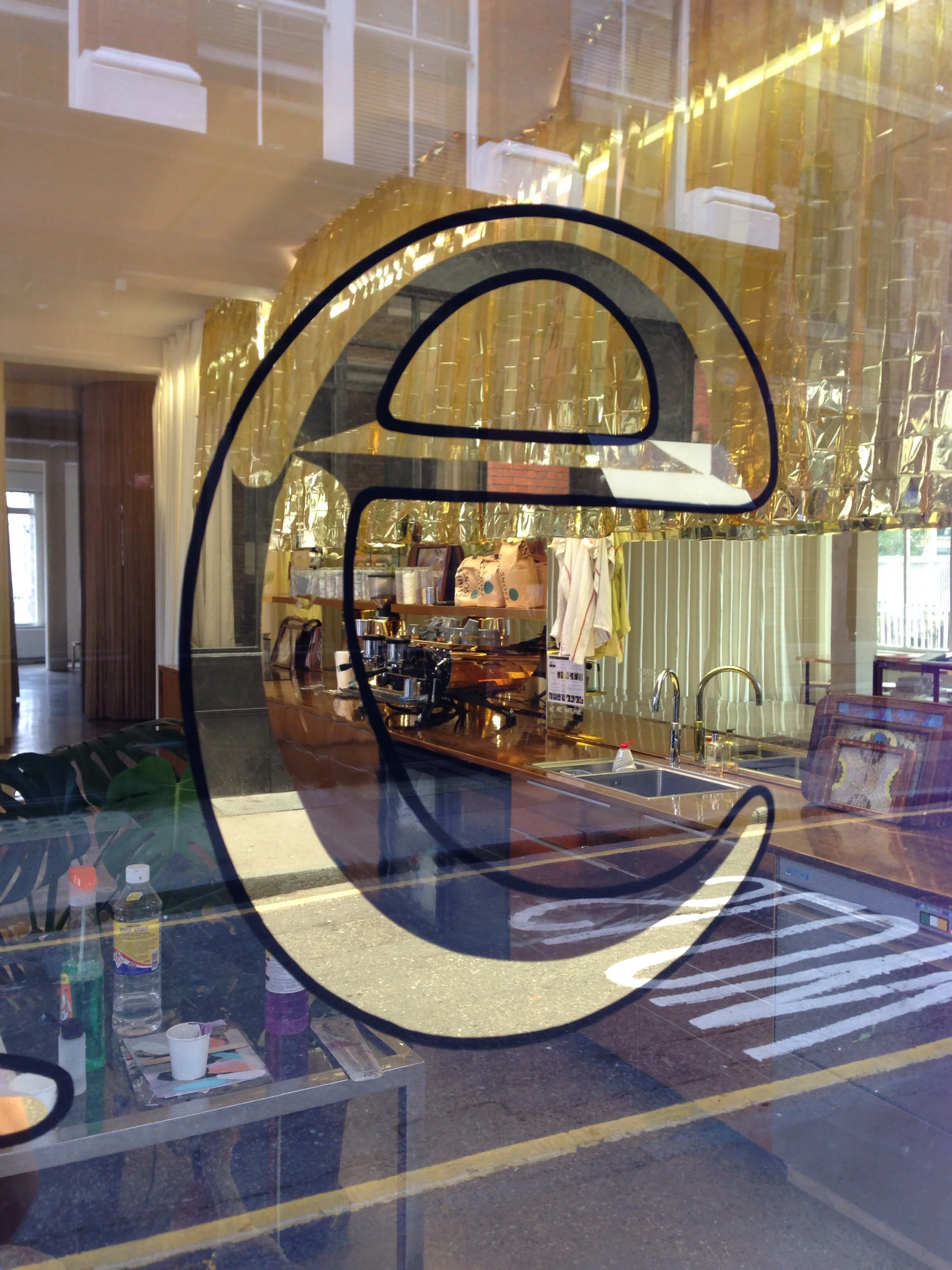 Once the back-up paint is dry the excess gold can be cleaned away, leaving the mirror sections on the other side of the glass. 