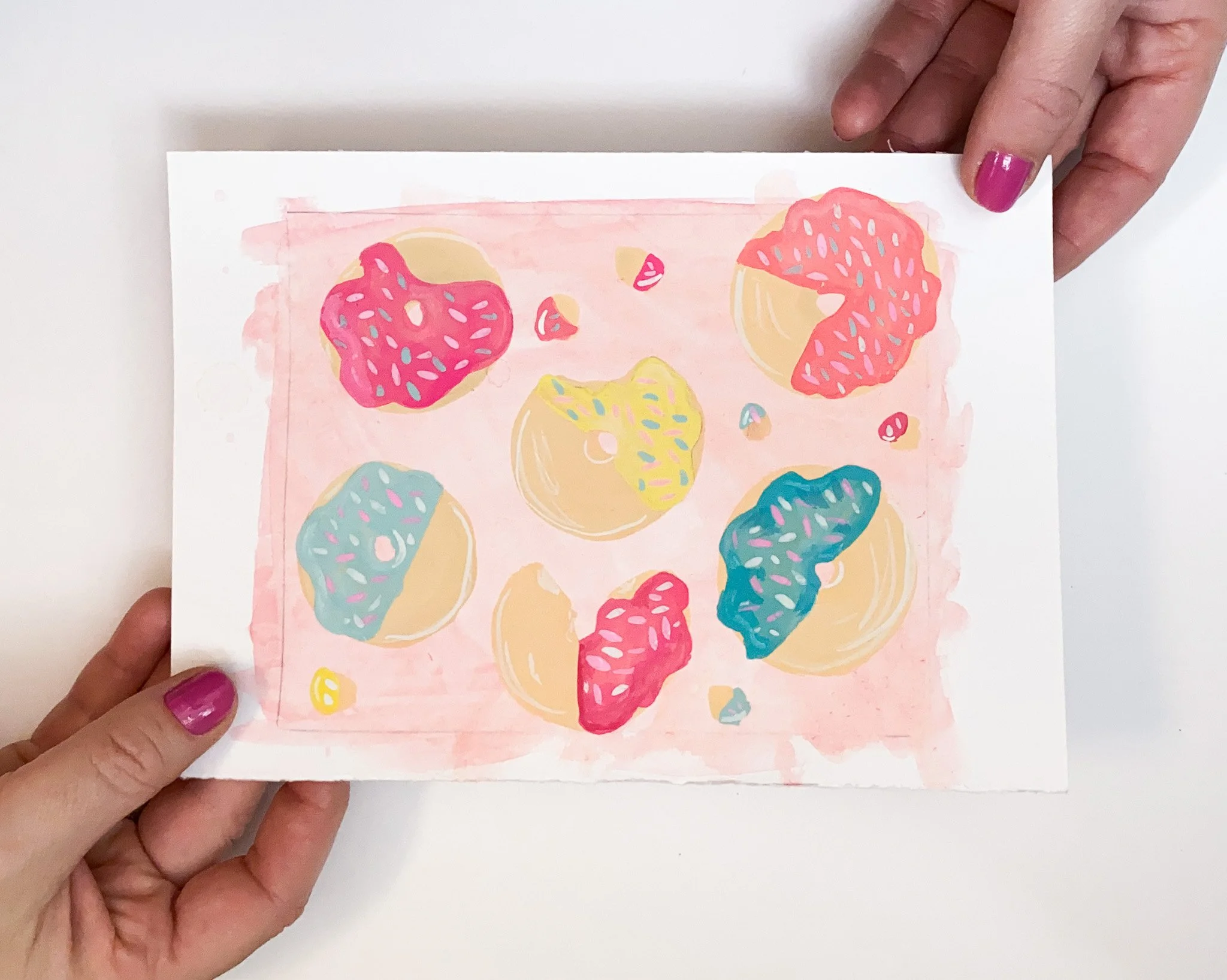 Hand-painted doughnut motif study in gouache, pastel tones arranged on paper exploration for textile pattern design