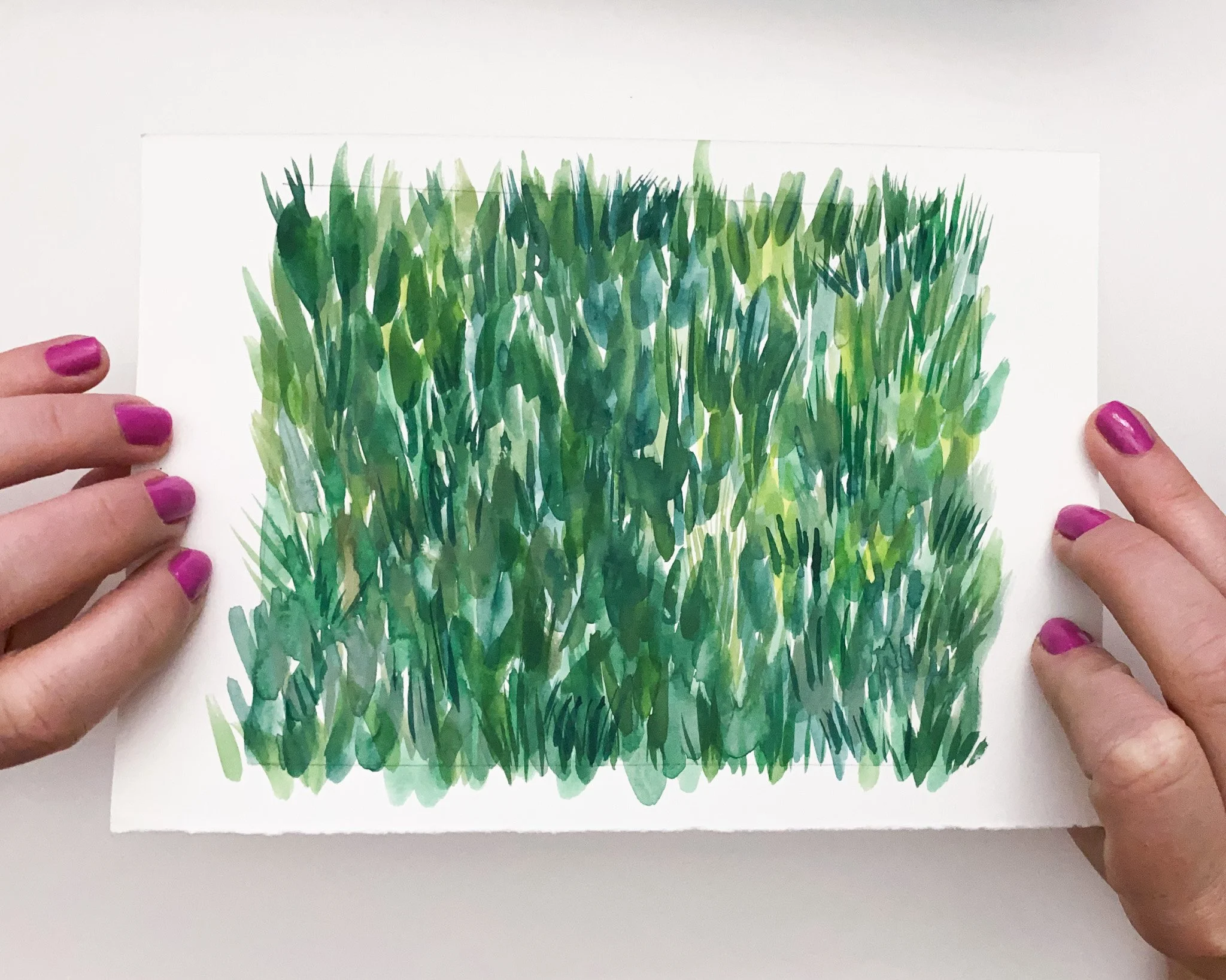 Hand-painted grass pattern study in watercolour and gouache, seamless repeat study held in hands