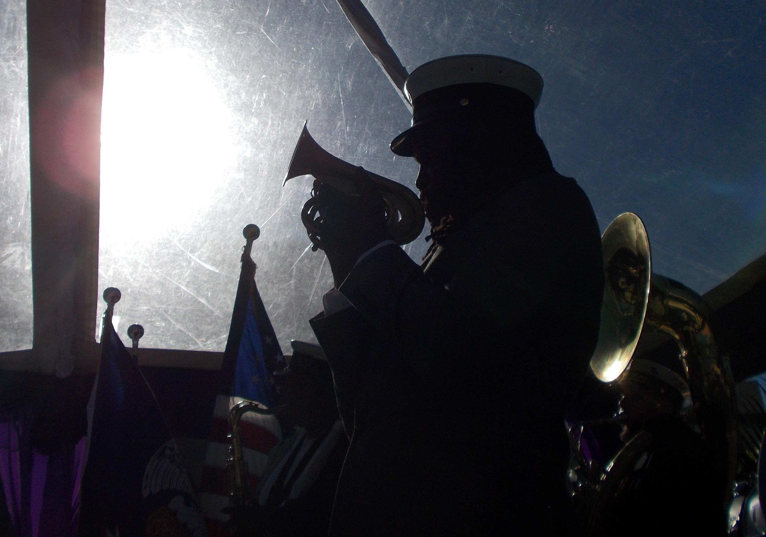 A member of the Tremé Brass Band is silhouetted against the sun as the band plays at the Rampart Streetcar Line ground breaking ceremony on January 28, 2015.