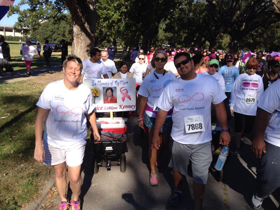  The Infinity Race for the Cure team walks together during the 2014 5K walk to raise awareness and funds for breast cancer. 