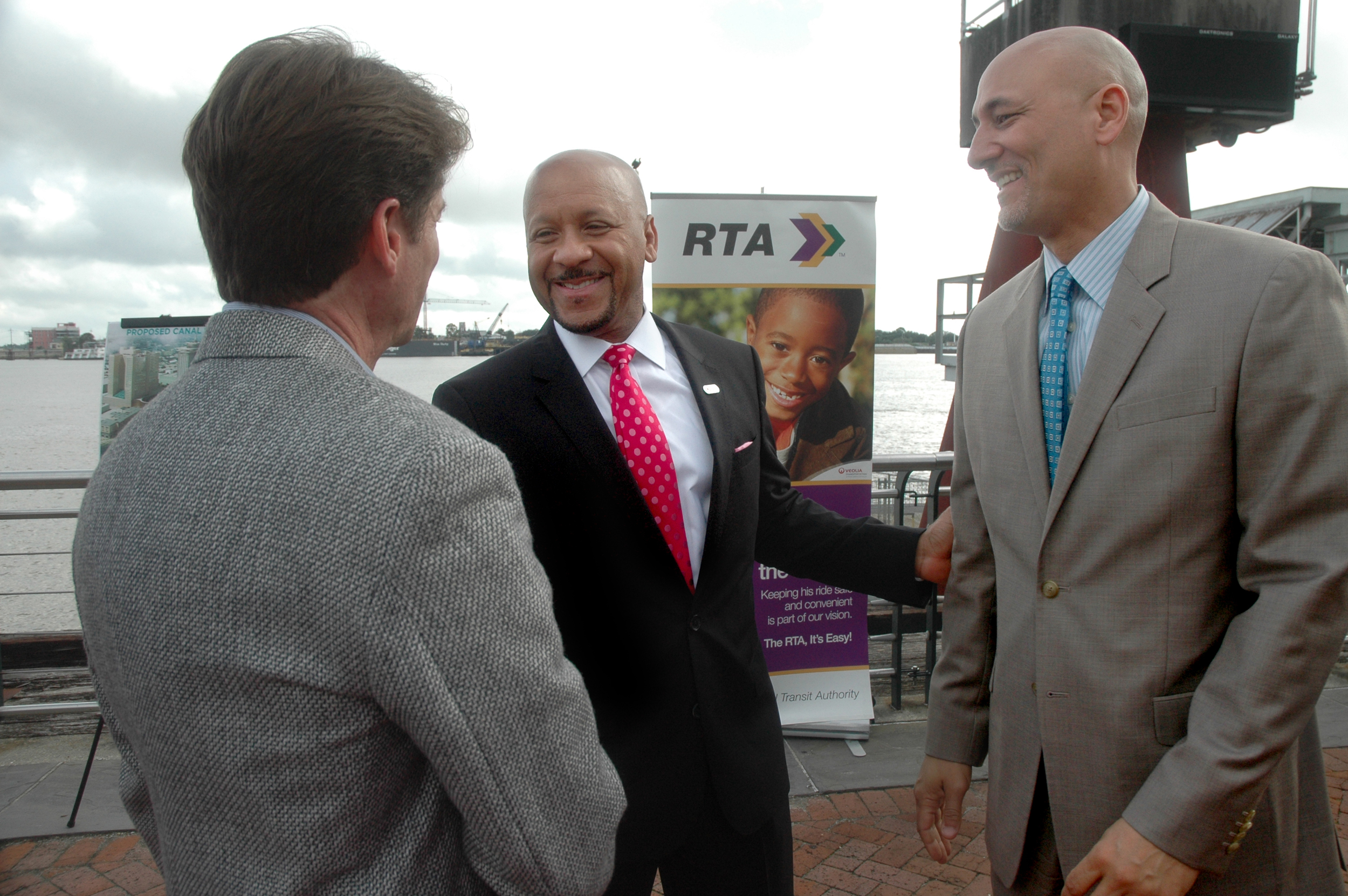  RTA CEO Justin Augustine, center, greets Infinity Engineering Principal Partners Bill Thomassie, left, and Raoul Chauvin after the press conference announcing the new Canal Street Ferry Terminal.&nbsp; 