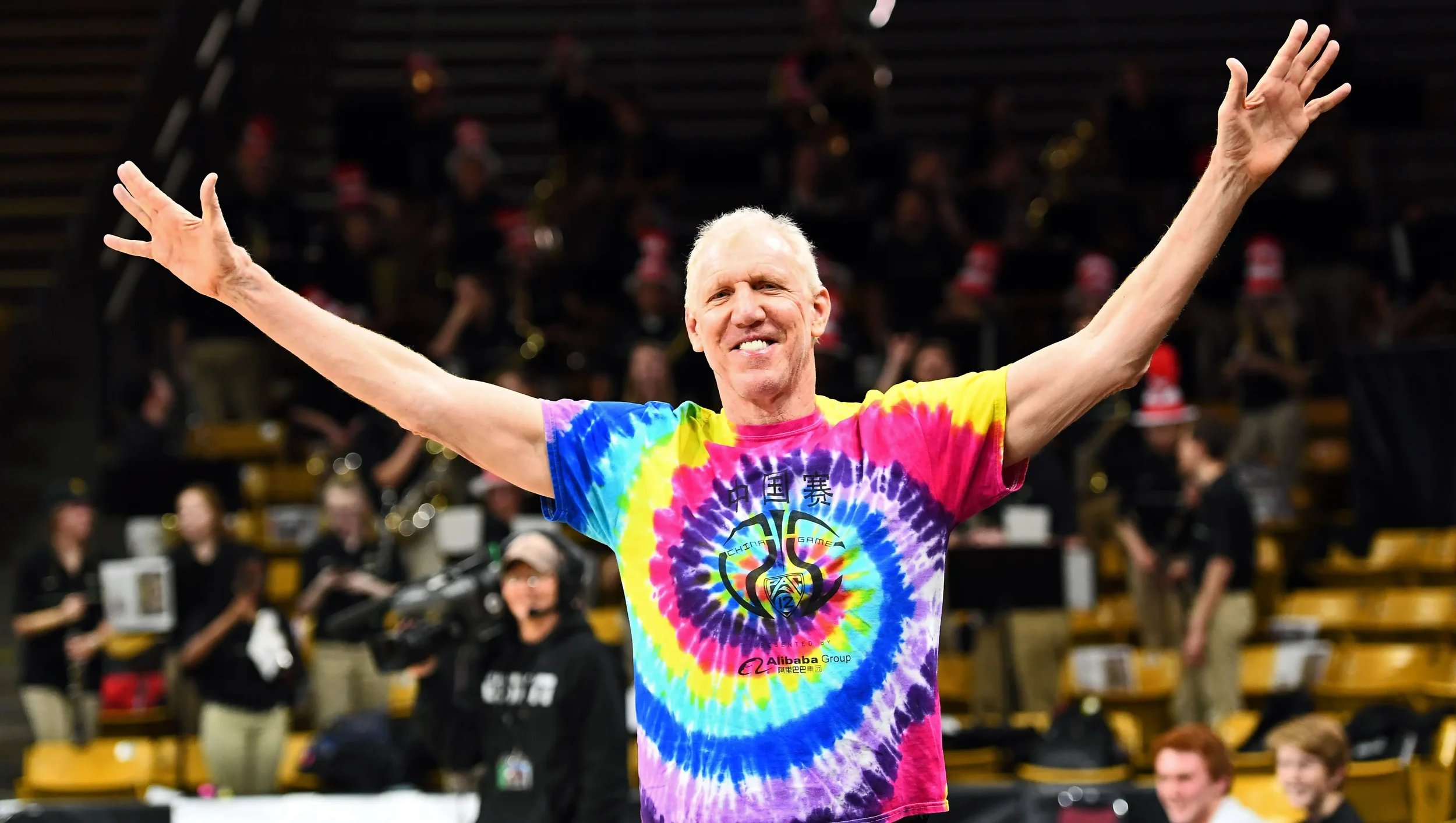 Bill Walton profile image with his hands up.