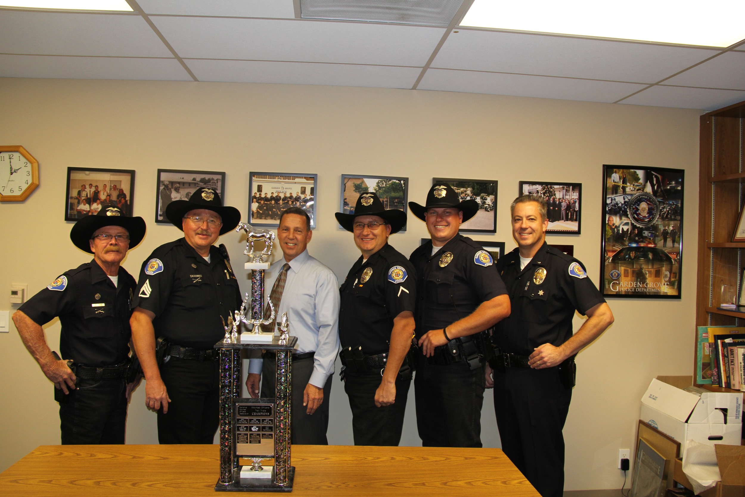 The Garden Grove team presents the trophy to Chief Kevin Raney
