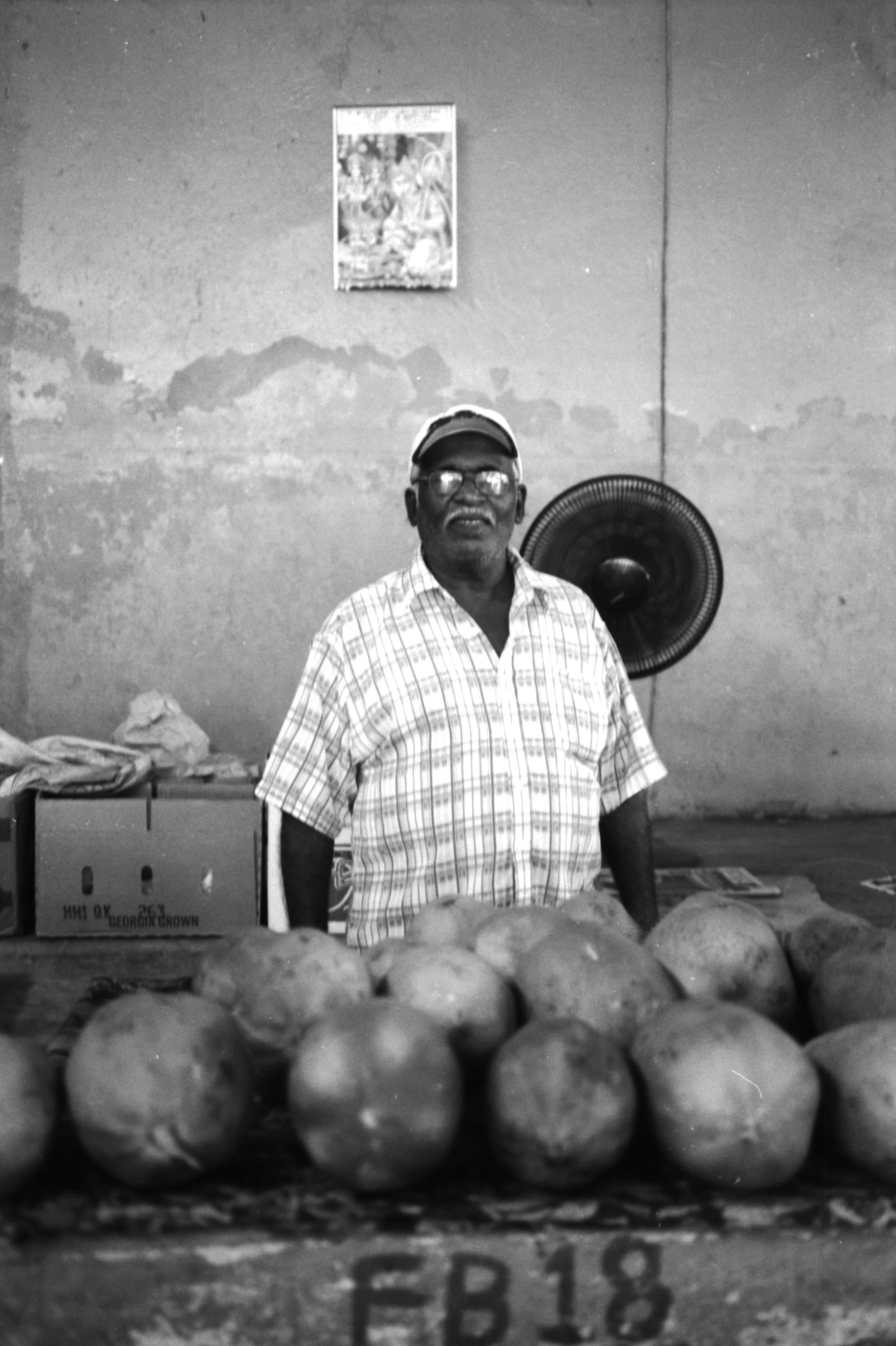 Local selling coconuts at the towns market. It amazed me at how he asked for his picture to be taken, he never asked what was going to be done with the image or anything like that. He was just happy to have his picture taken even though he would mostly never see the outcome of it.