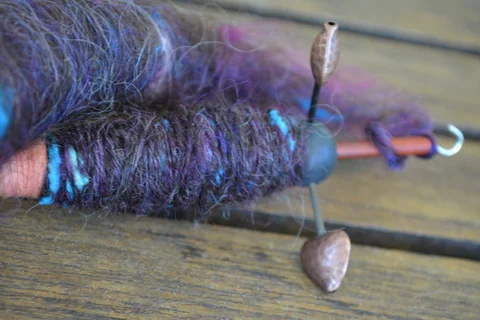 Trindle drop spindle with black English Leicester and silk noil