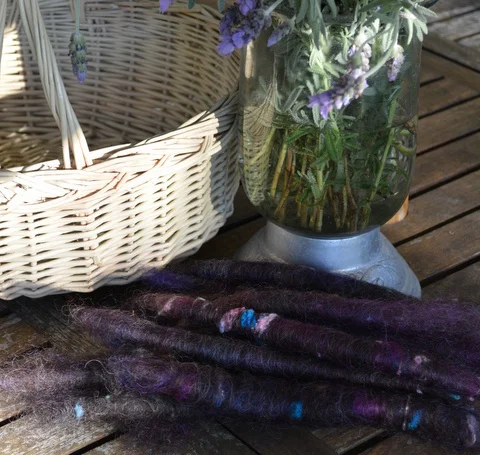 Rolags of black English Leicester with silk noil ready to spin