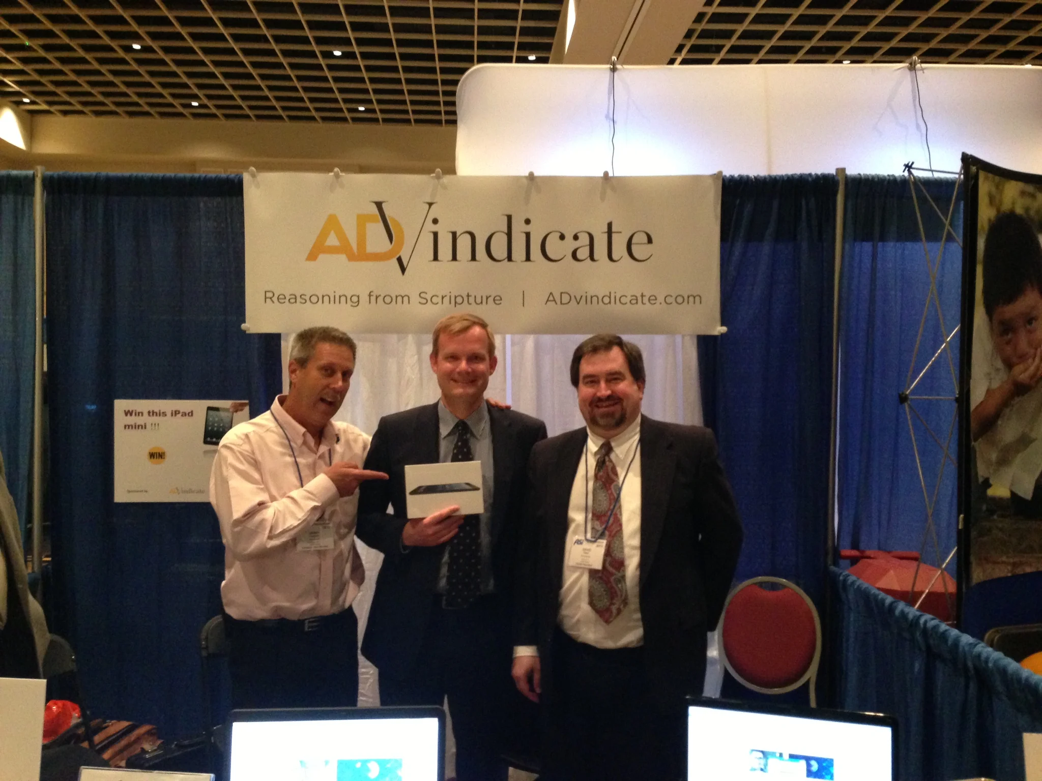 Gerry Wagoner and David Read stand with Marcel Wiggers, winner of the iPad Mini.