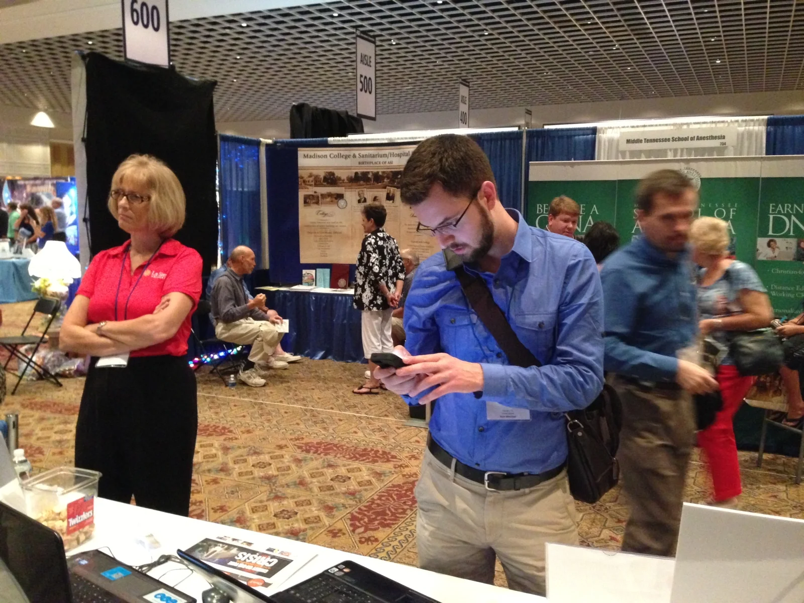 Visitors talking and signing up for the iPad Mini drawing.
