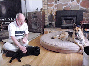 This peaceful scene would have been quite impossible to stage six months ago. Thanks to some very committed owners, two cats and the formerly predatory dog are living together in harmony. Photo and caption courtesy of The Whole Dog Journal .