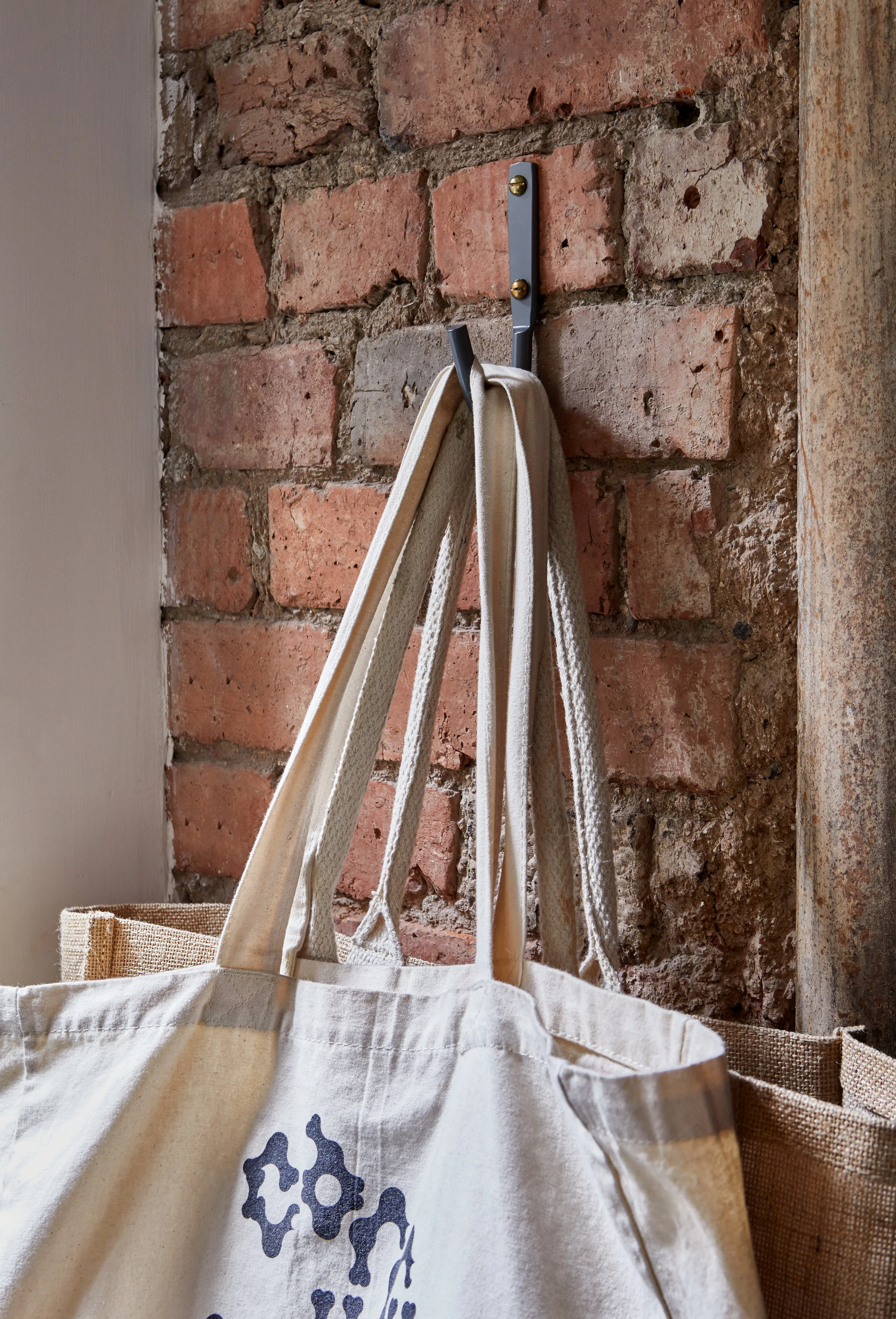 Large grey hook for utility room bag storage