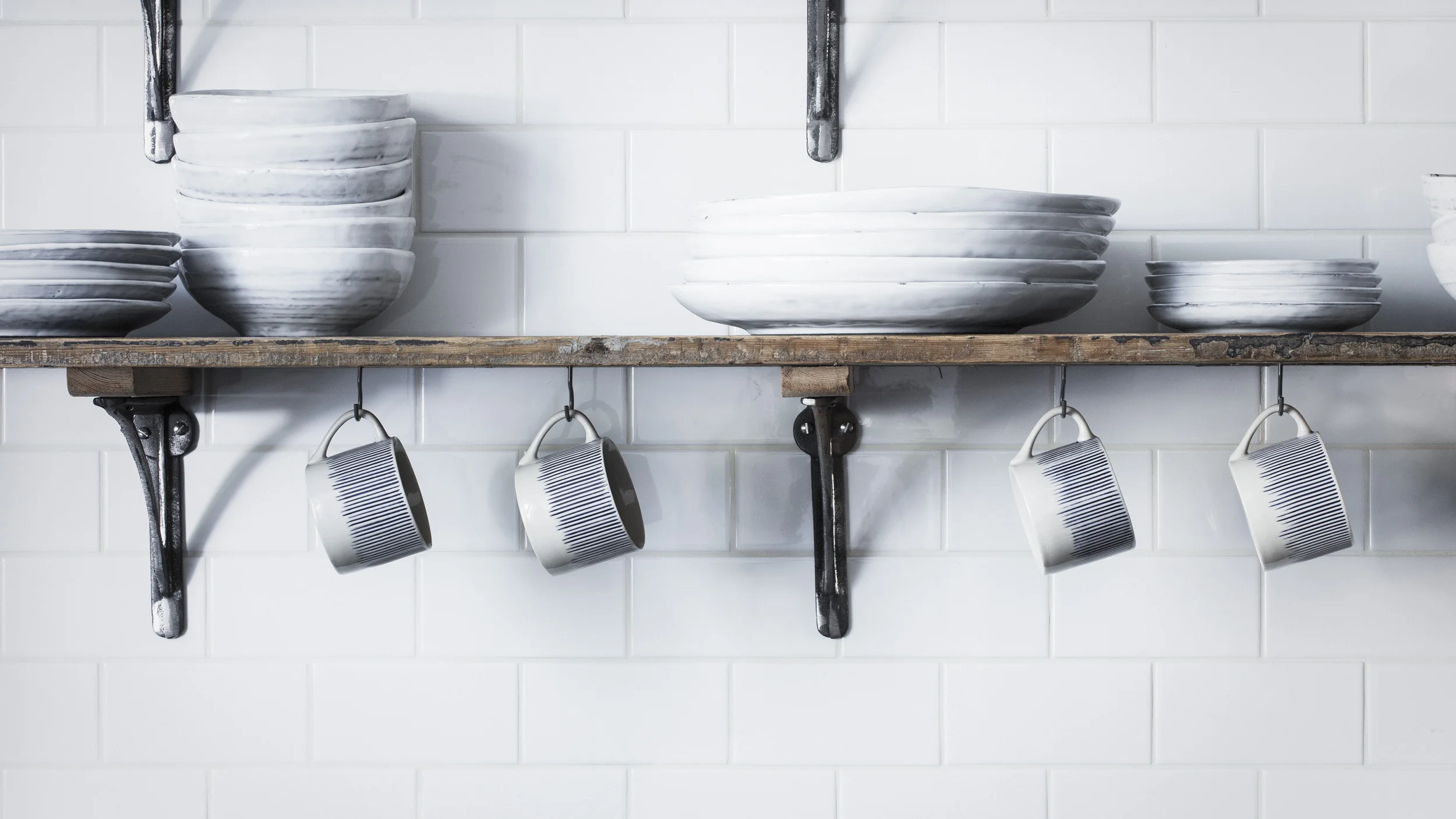 small grey screw hook for hanging mugs under shelf