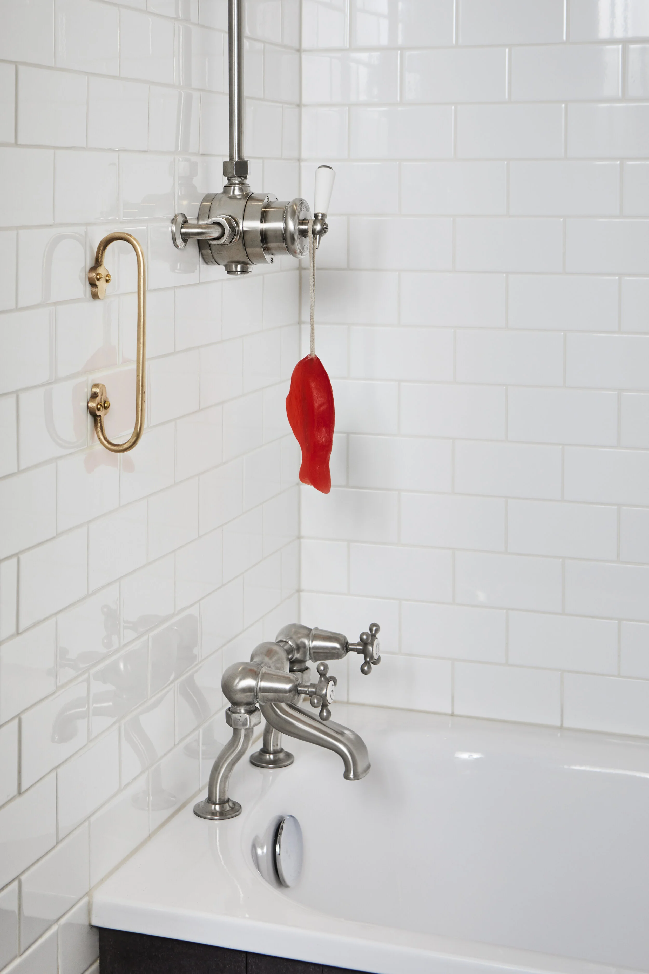 Cast bronze shower handrail in bathroom