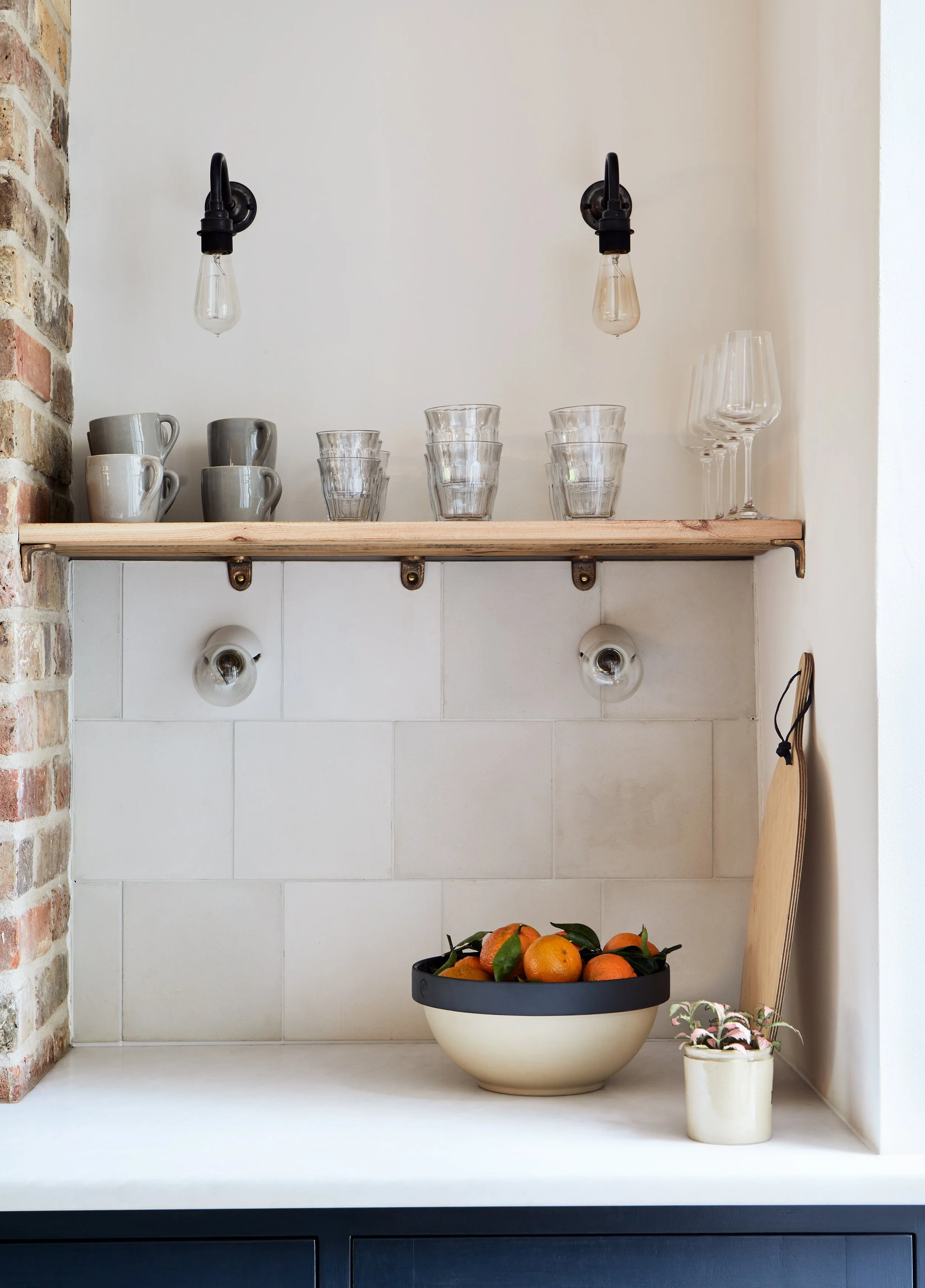 Small cast bronze brackets for kitchen shelves