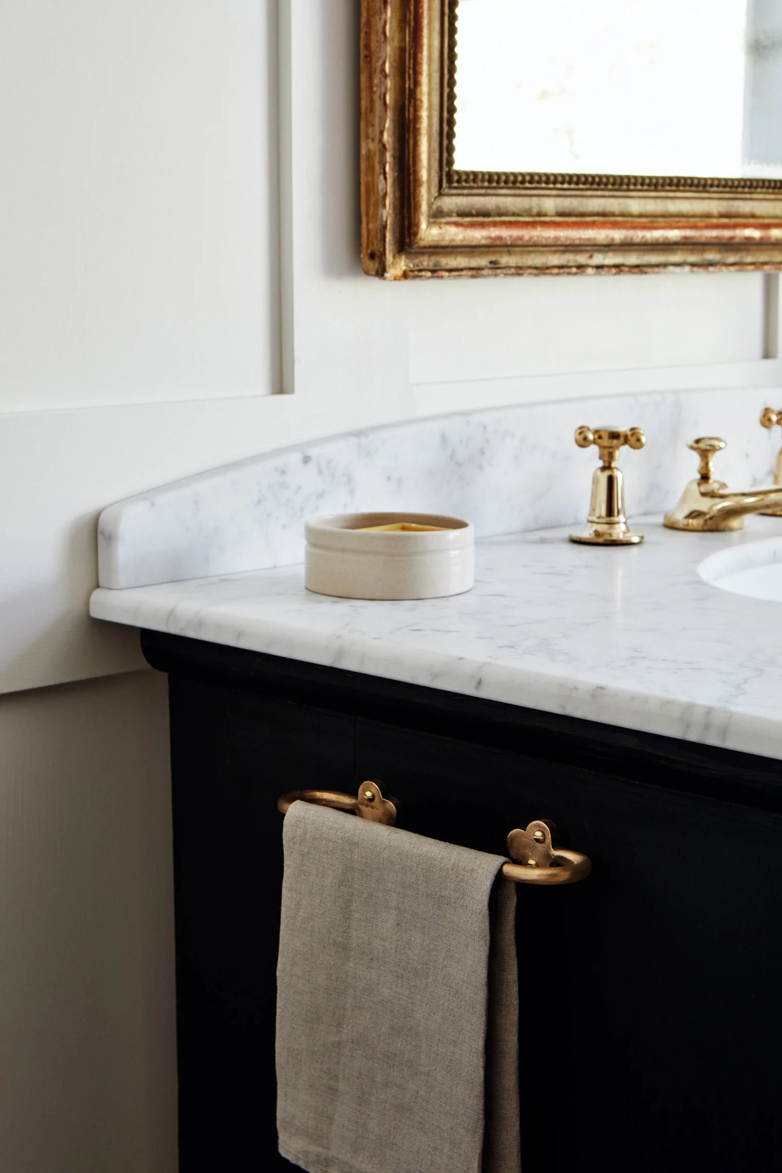 Hand Towel Rail, Cast Bronze rail fixed to side of black antique painted basin unit with marble, featuring brass basin taps and a stoneware soap pot, with a linen hand towel. Made in raw bronze.