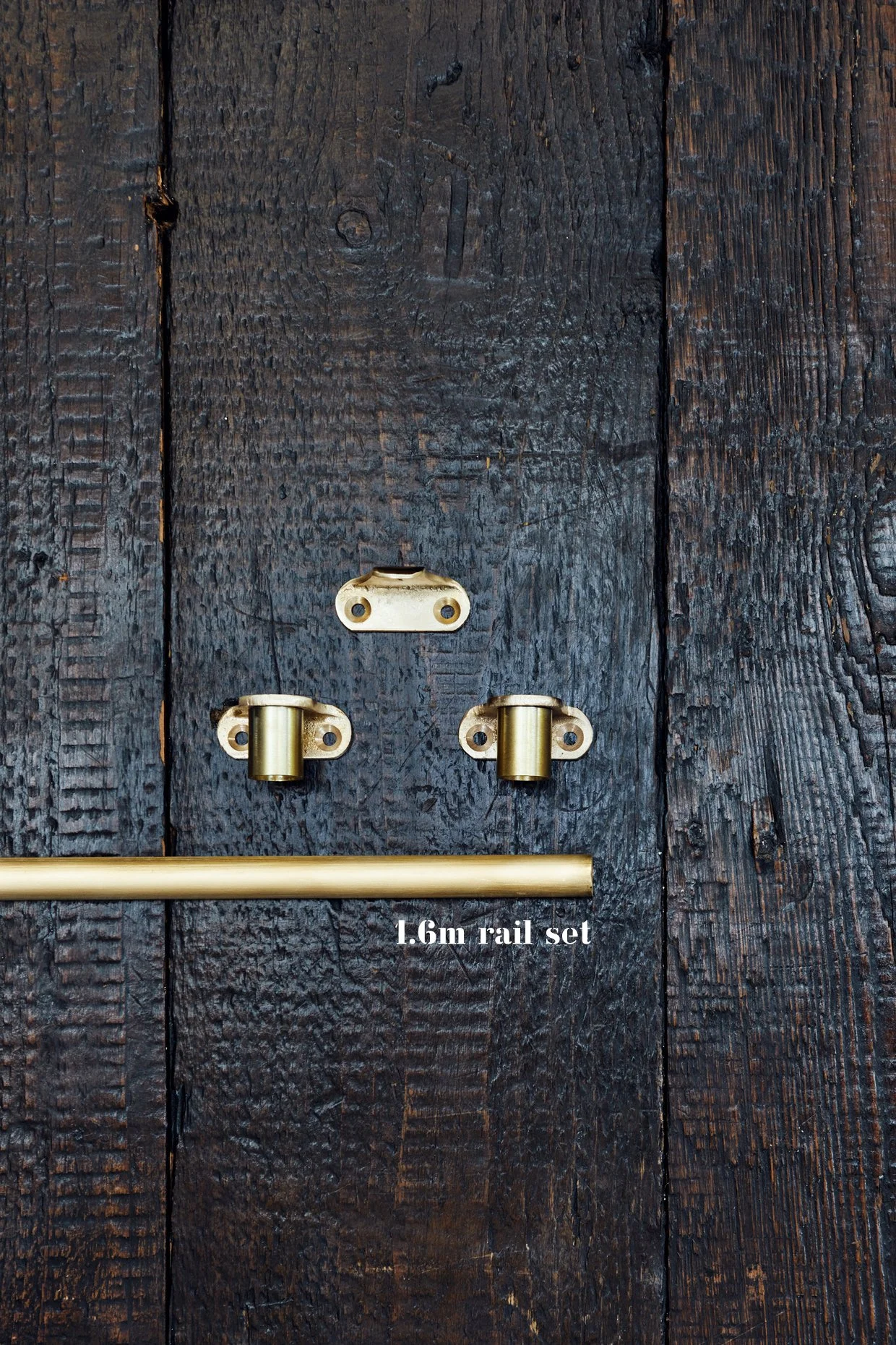 "Unlacquered Brass Café Curtain Rail Set Includes: 2 café end brackets, 1 center bracket, and 1 section of rail Arranged on a timber board Text overlay: '1.6m Rail Set'"