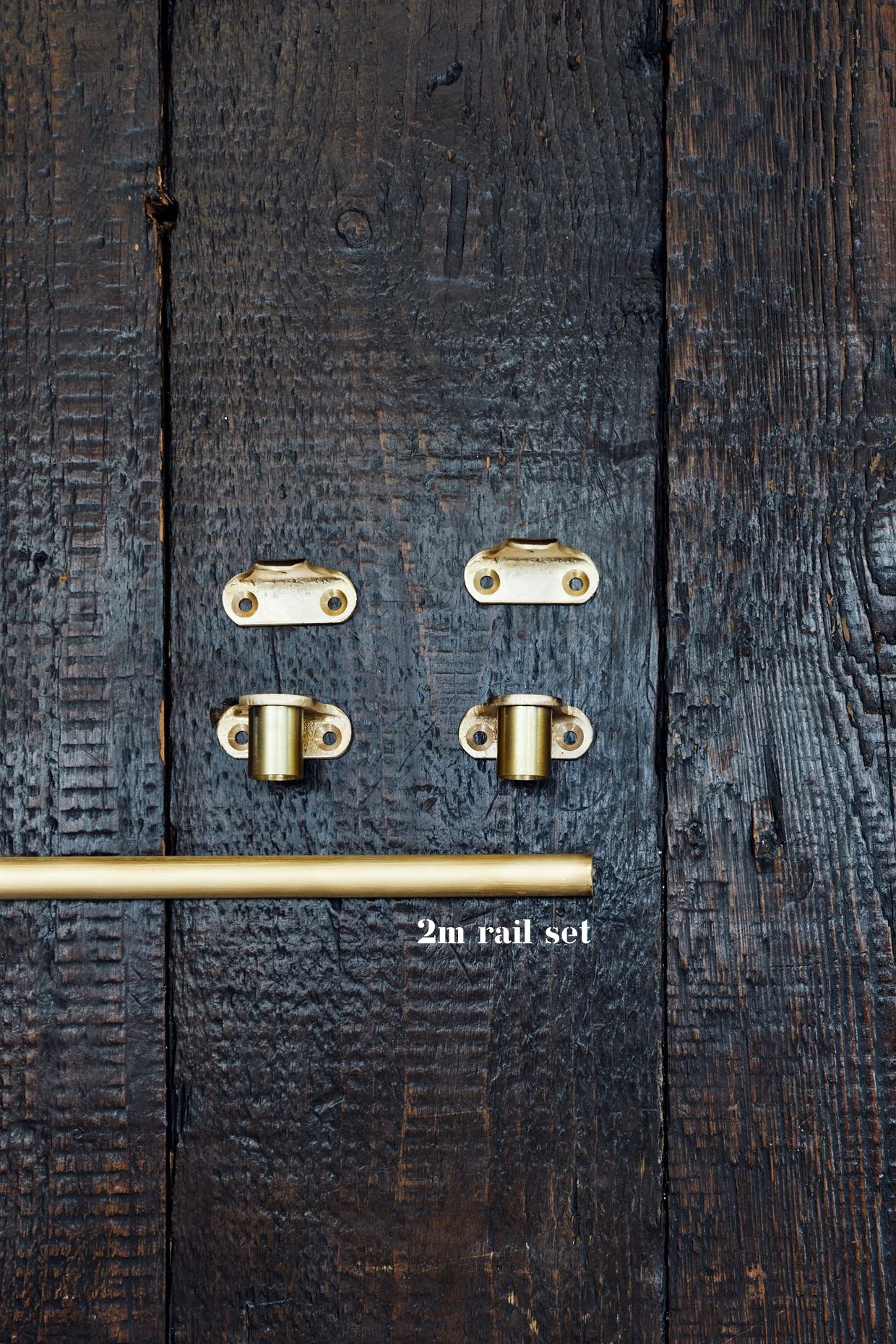 "Unlacquered Brass Café Curtain Rail Set Includes: 2 café end brackets, 2 center brackets, and 1 section of rail Arranged on a timber board Text overlay: '2m Rail Set'"
