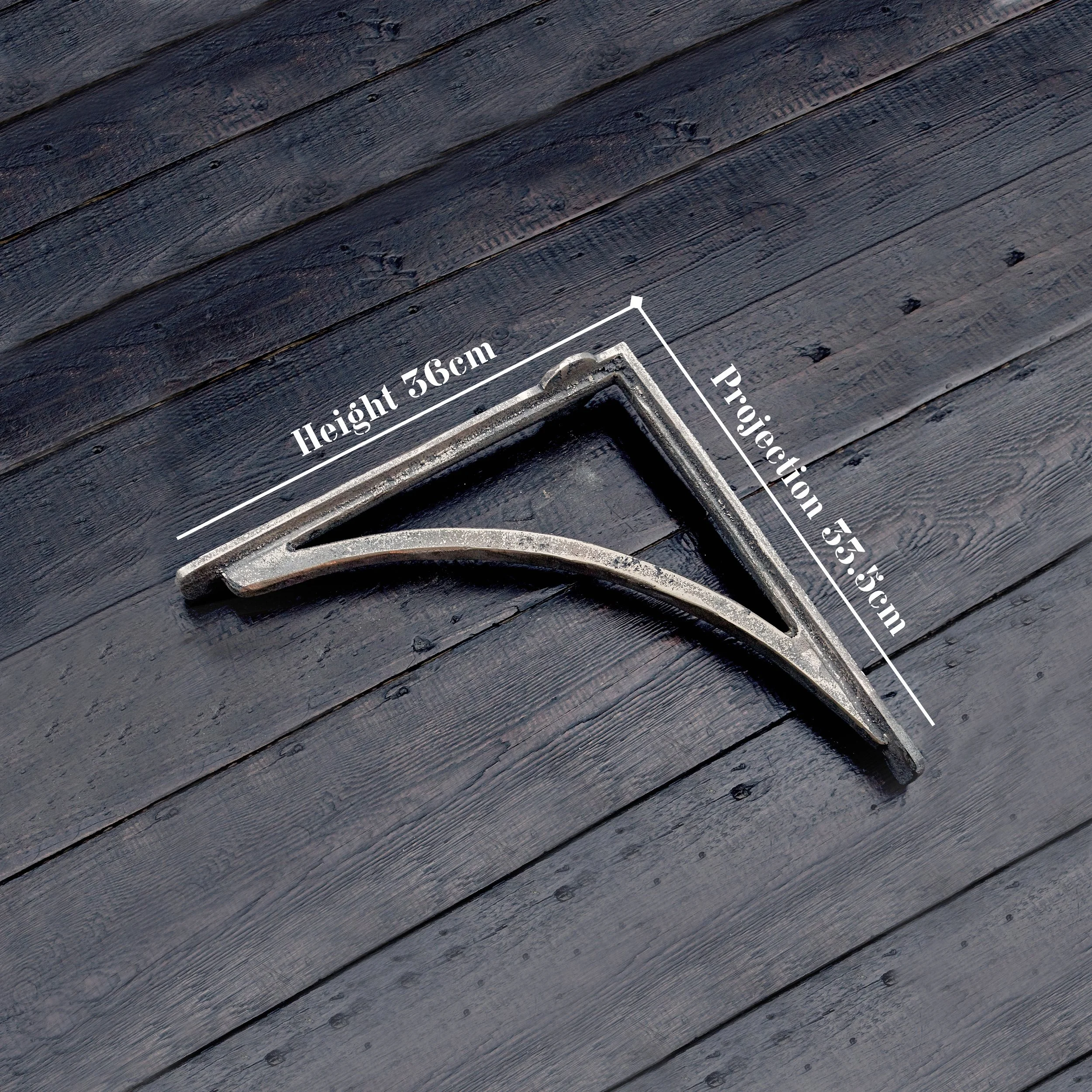 Cast Bronze Sink Brackets – Small, Medium & Large. The small bracket is laying on a timber display board, highlighting its solid sand-cast bronze construction and raw finish.