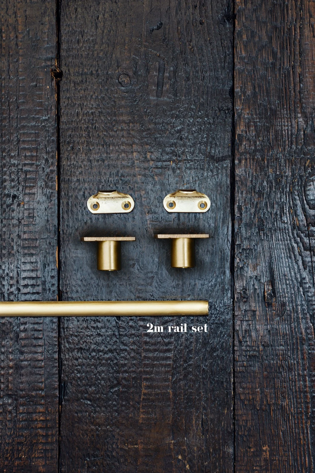 Unlacquered Brass Café Curtain Rail Set with Recessed Brackets End brackets x 2, 2 center brackets, and 1 section of rail laid out on timber board. Text shows 2m rail set. Made in brass.