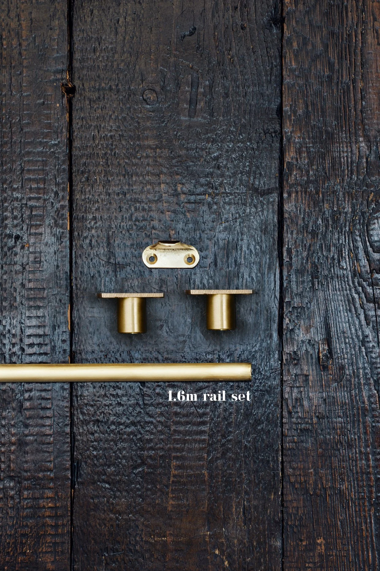 Unlacquered Brass Café Curtain Rail Set with Recessed Brackets End brackets x 2, 1 center bracket, and 1 section of rail laid out on timber board. Text shows 1.6m rail set. Made in brass.