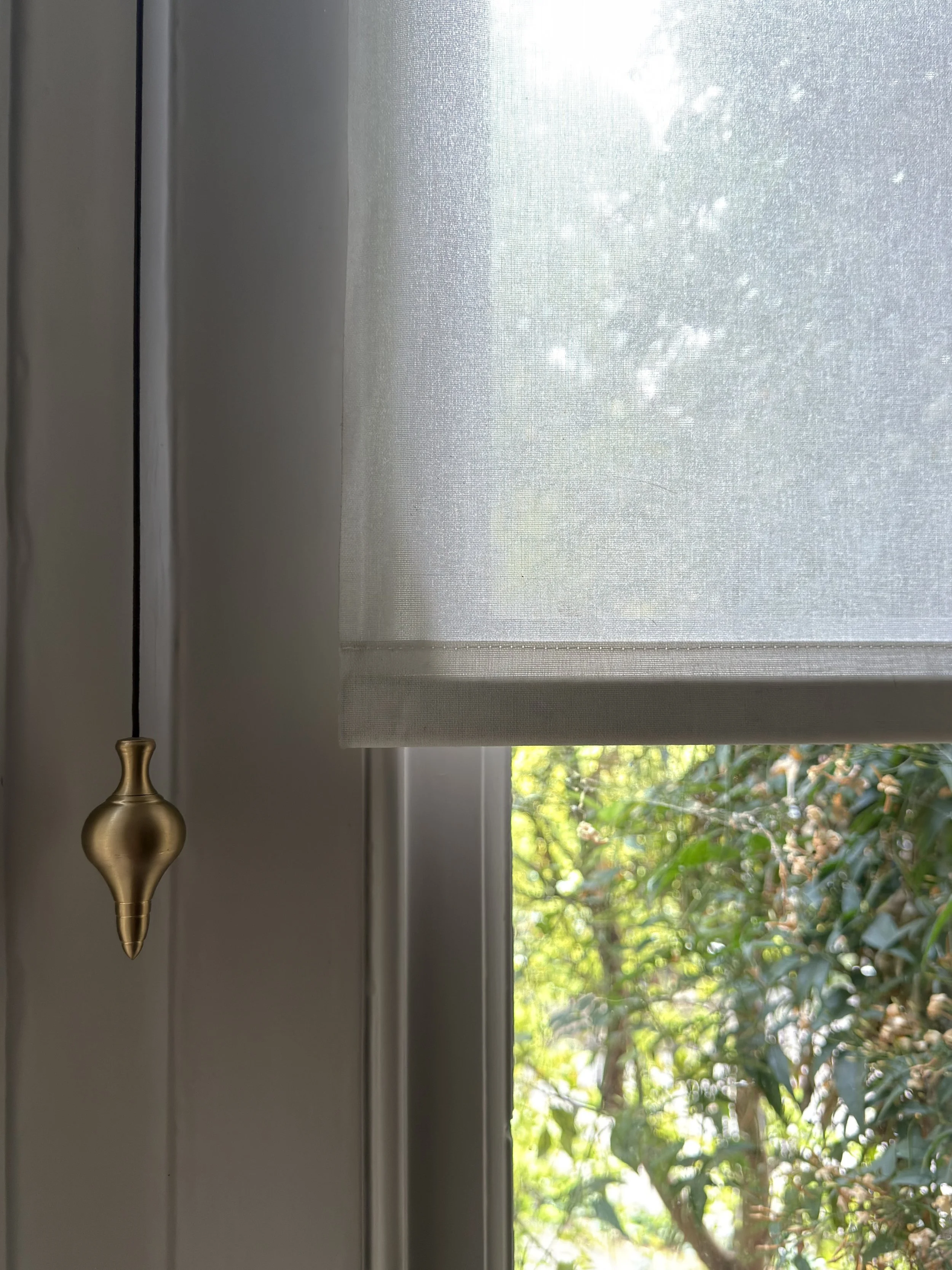 unlacquered-brass-cord-weight-hanging-on-blind-cord.jpg