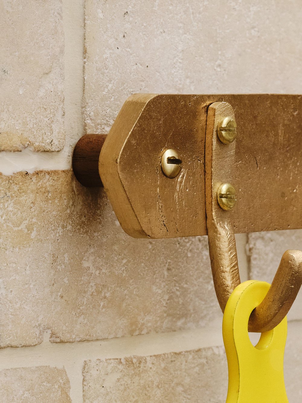 Detail view of the mahogany timber spacer behind the pan rack, creating the clean shadow gap when wall-mounted.