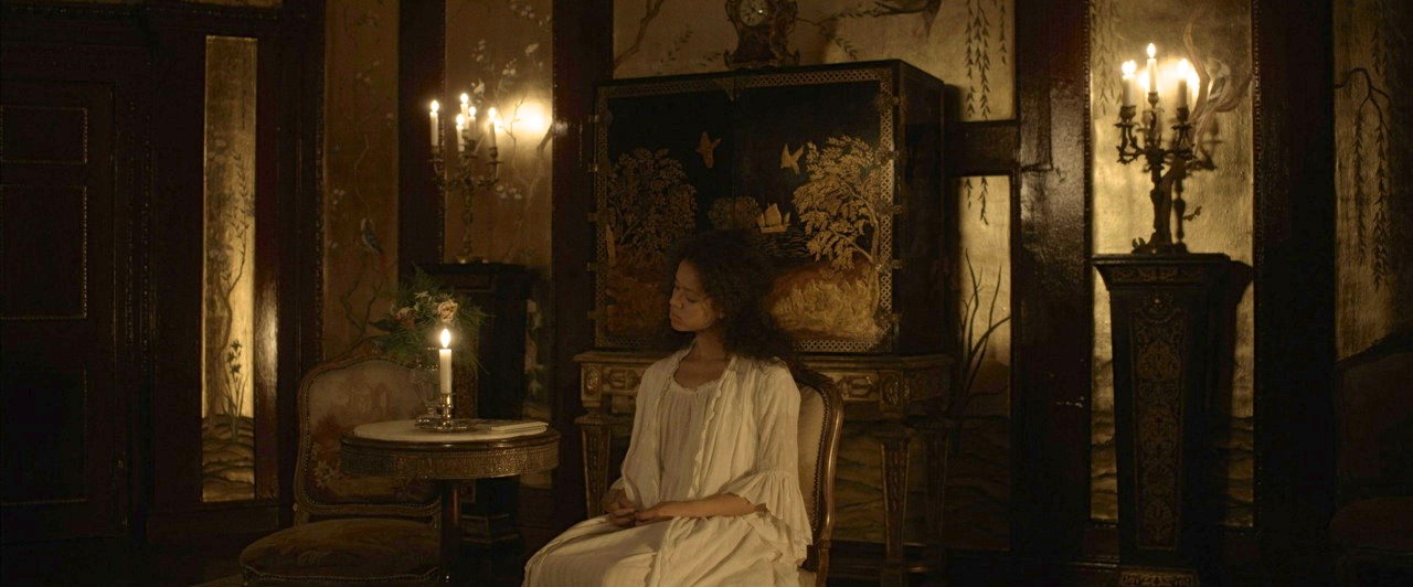 Set build on location for Dido and Elizabeth's bedroom in Bloomsbury Square; woodwork panelling painted and grained as mahogany, polished timber floor laid, inset panels gold leafed and hand painted with Chinoiserie, chandeliers hung, curtains made and fully dressed.