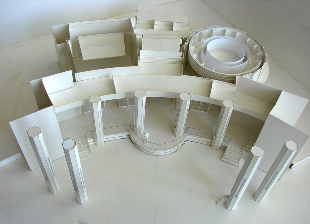 Above: Scale white-card model of the set with miniature figure to show scale to discuss the scripted with Director and DoP .
