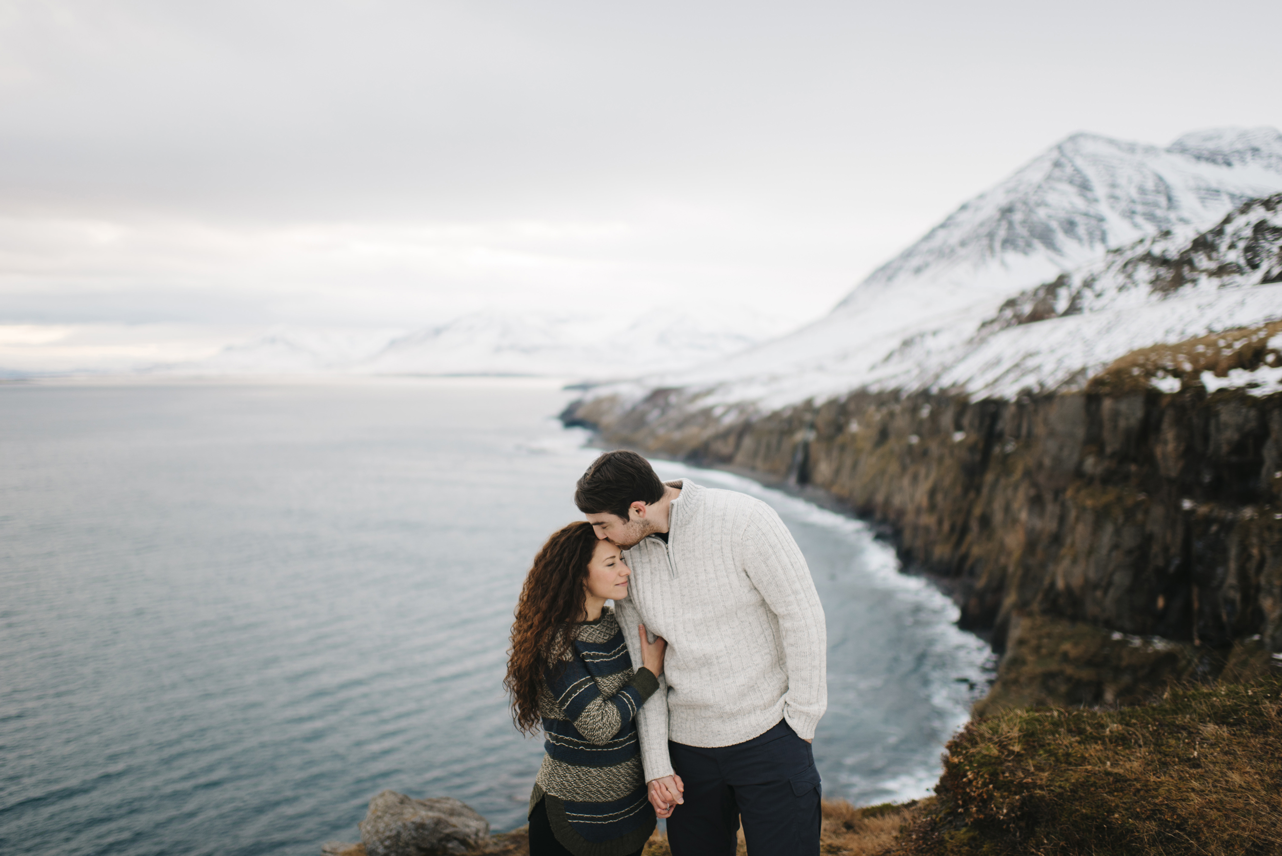 He steals a forehead kiss during Adventure Honeymoon Photography session by Iceland Elopement Photographer Colby and Jess colbyandjess.com