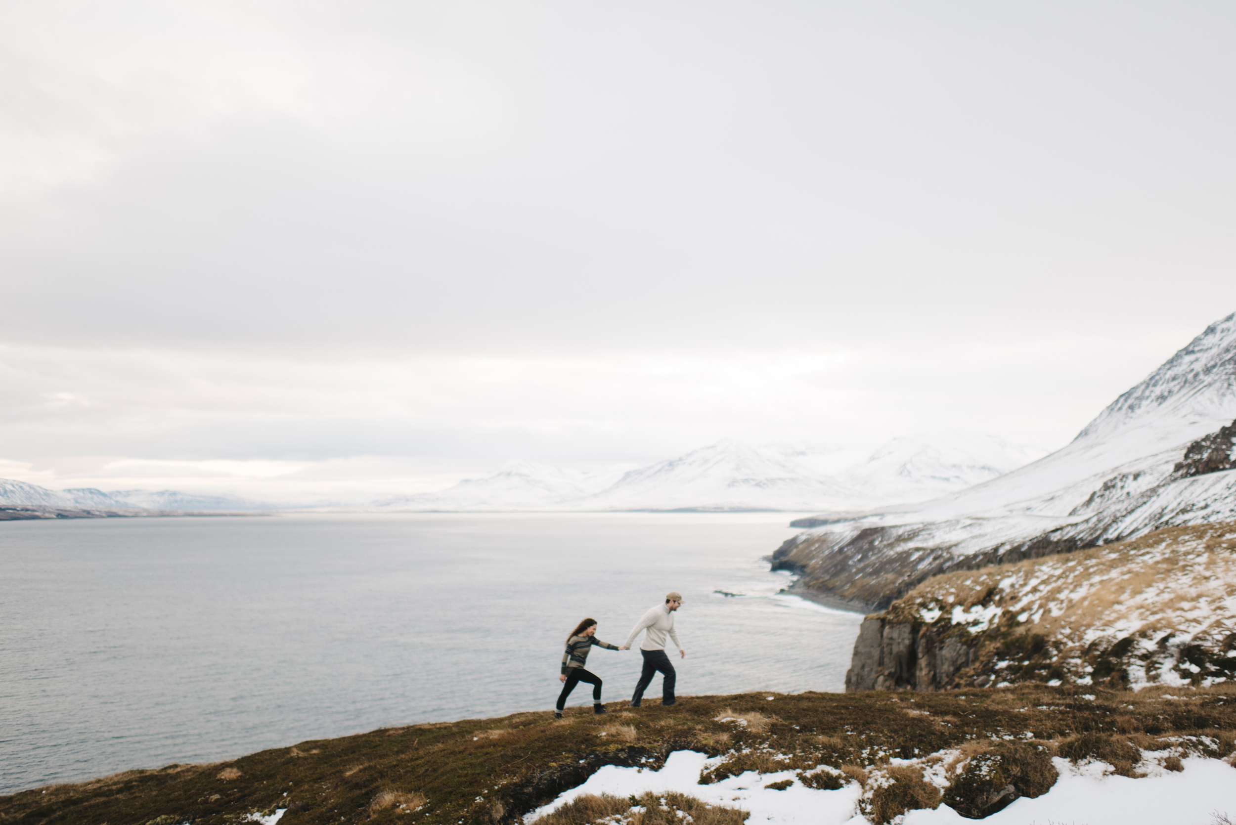 Couple exploring Fjords during Adventure Honeymoon Photography Session by Iceland Elopement Photographer Colby and Jess colbyandjess.com