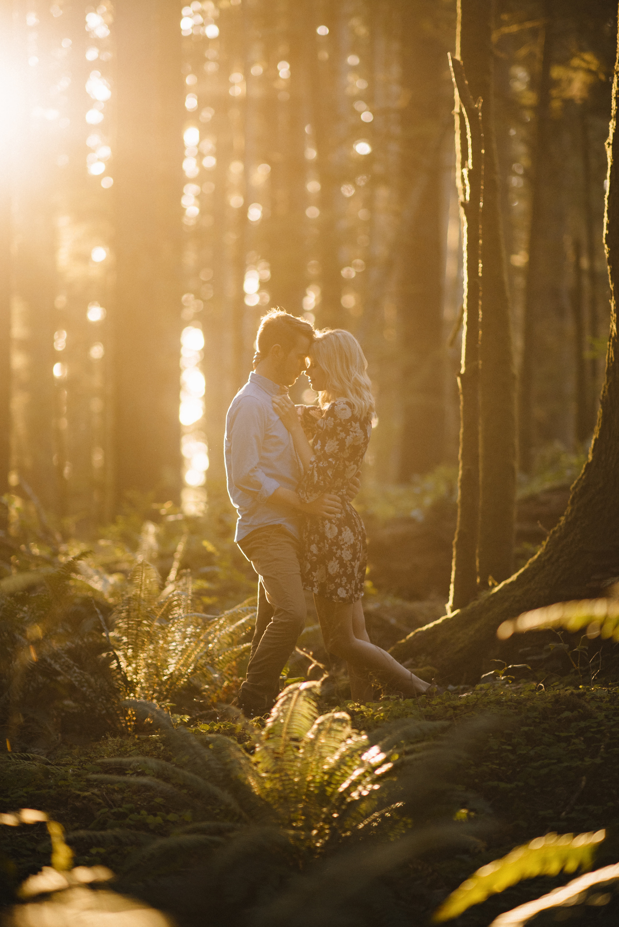 A married couple snuggles in the forest on Oregon Coast.  Adventurous couples photography by Colby Moore.