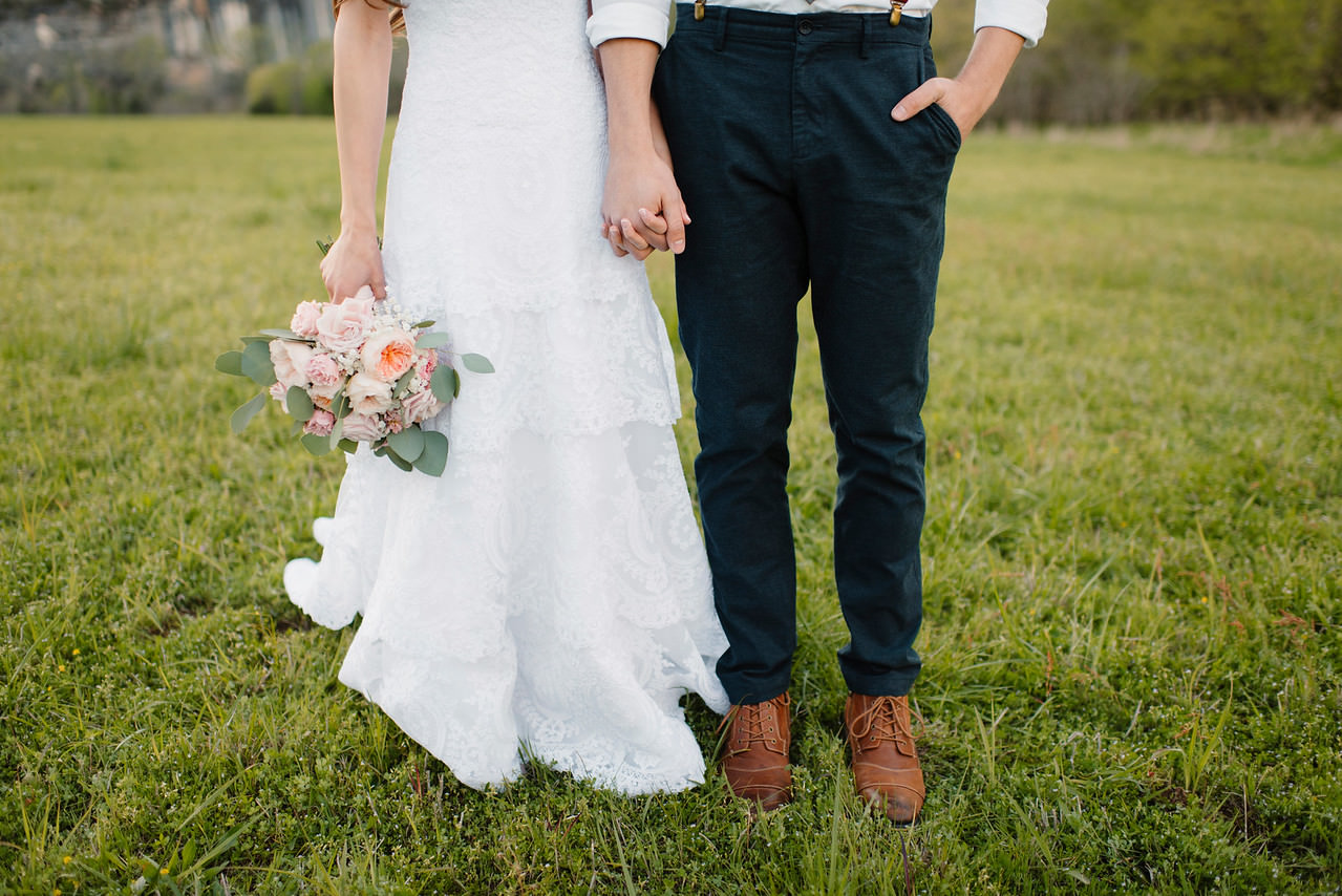 A groom and bride hold hands at Steele Creek after their Buffalo River Wedding by Arkansas Adventure Destination Photographer Colby and Jess