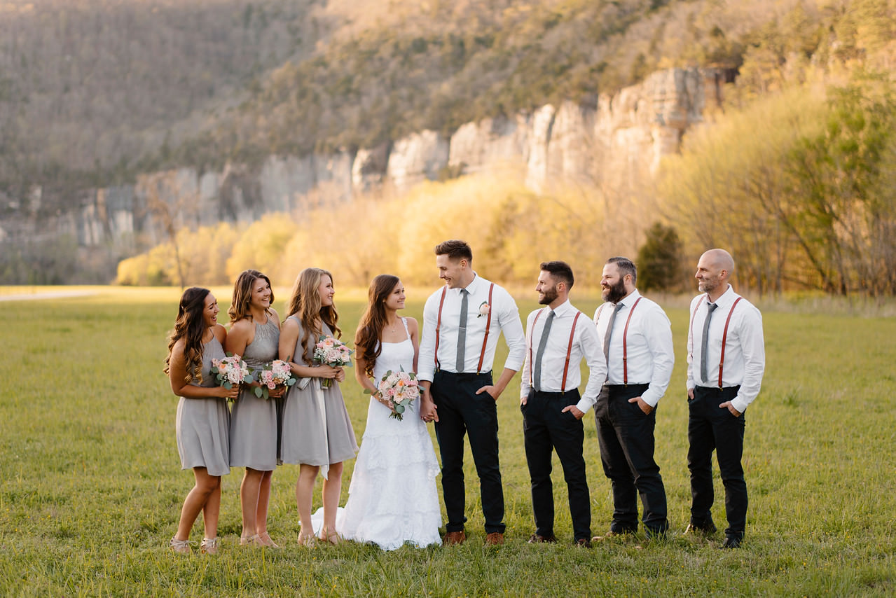 A bridal party stands in front of the bluffs after their Buffalo River Wedding with Arkansas Adventure Destination Photographer Colby and Jess