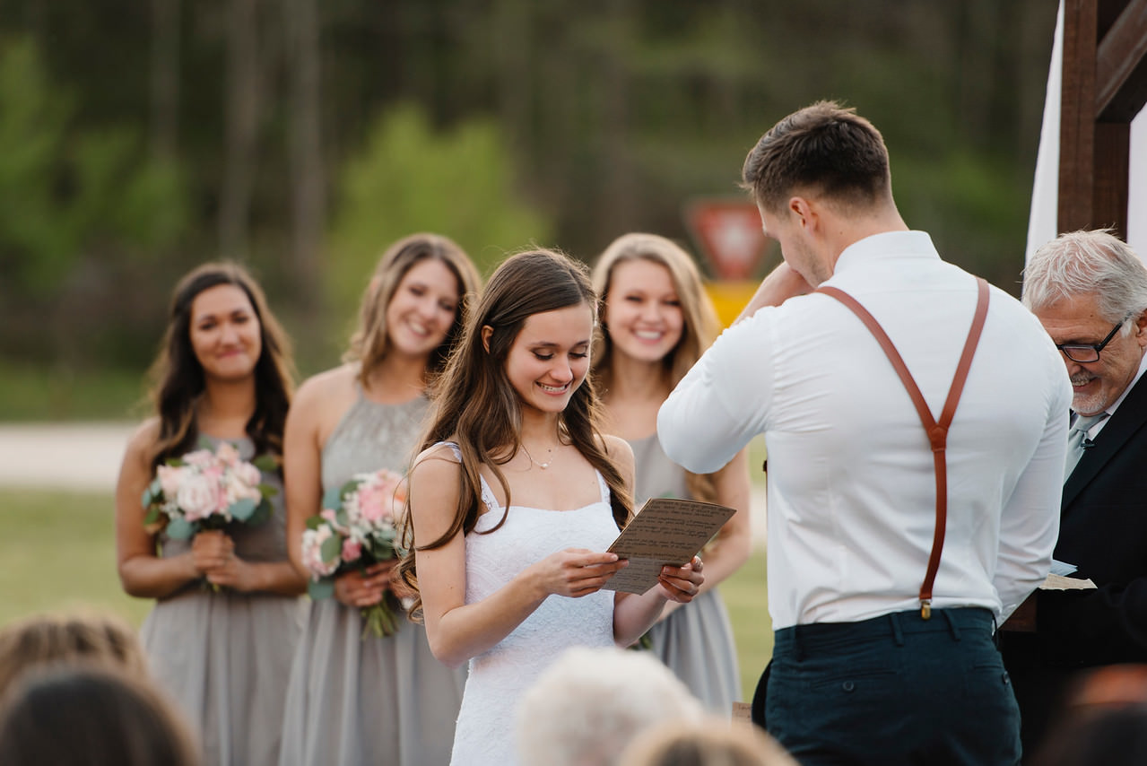 A bride reads her vows during her romantic Buffalo River Wedding with Arkansas Adventure Destination Photographer Colby and Jess