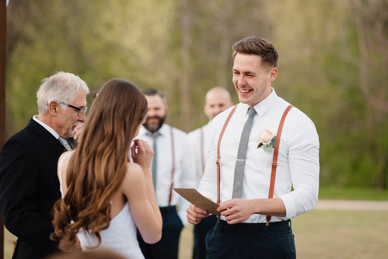 An emotional groom reads his vows to his bride during their Buffalo River Wedding with Arkansas Adventure Destination Photographer Colby and Jess