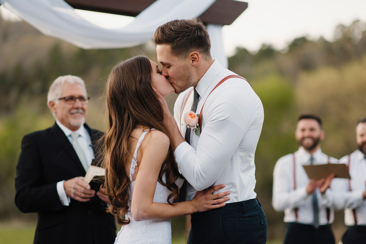 A bride and groom kiss during their Buffalo River Wedding by Arkansas Adventure Destination Photographer Colby and Jess