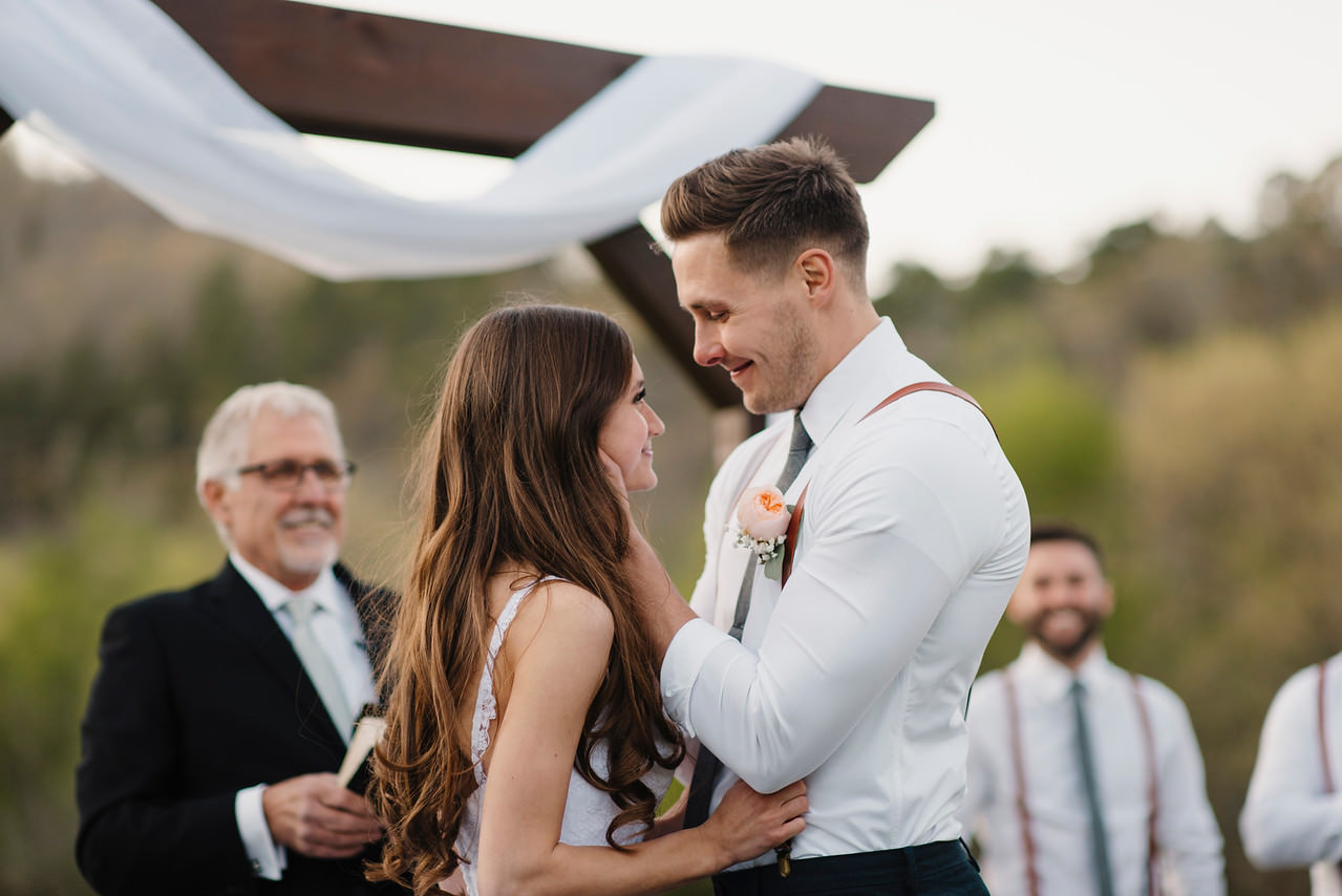 A bride and groom go in for a kiss during their Buffalo River Wedding with Arkansas Adventure Destination Photographer Colby and Jess