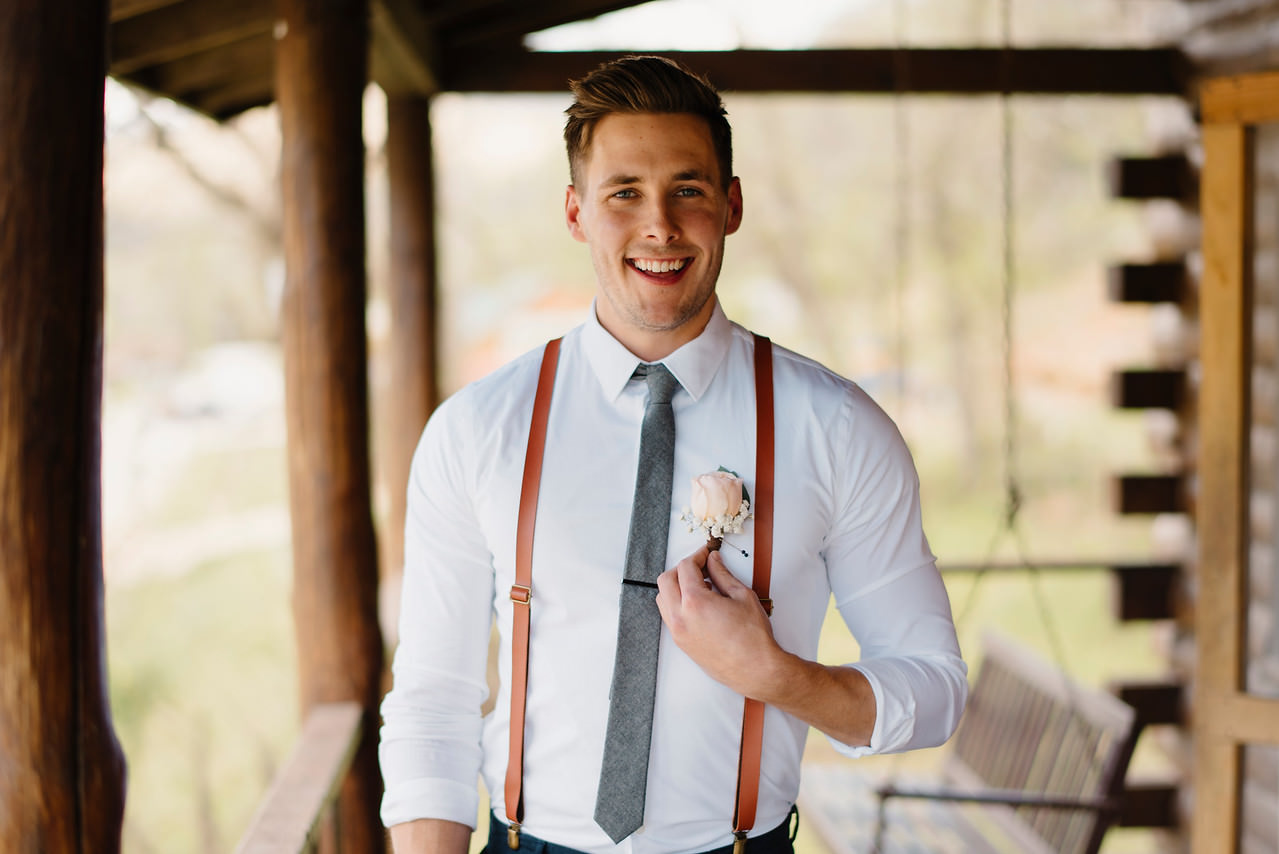 A groom smiles with excitement before his Outdoor Buffalo River Wedding by Arkansas Adventure Destination Wedding Photographer Colby and Jess