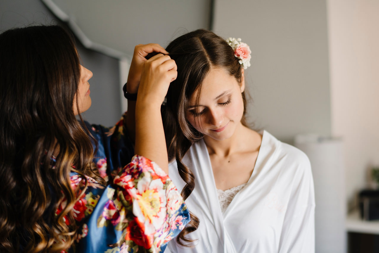 A beautiful bride has her hair done for her Outdoor Ozarks Wedding by Buffalo River Adventure Elopement Photographers Colby and Jess