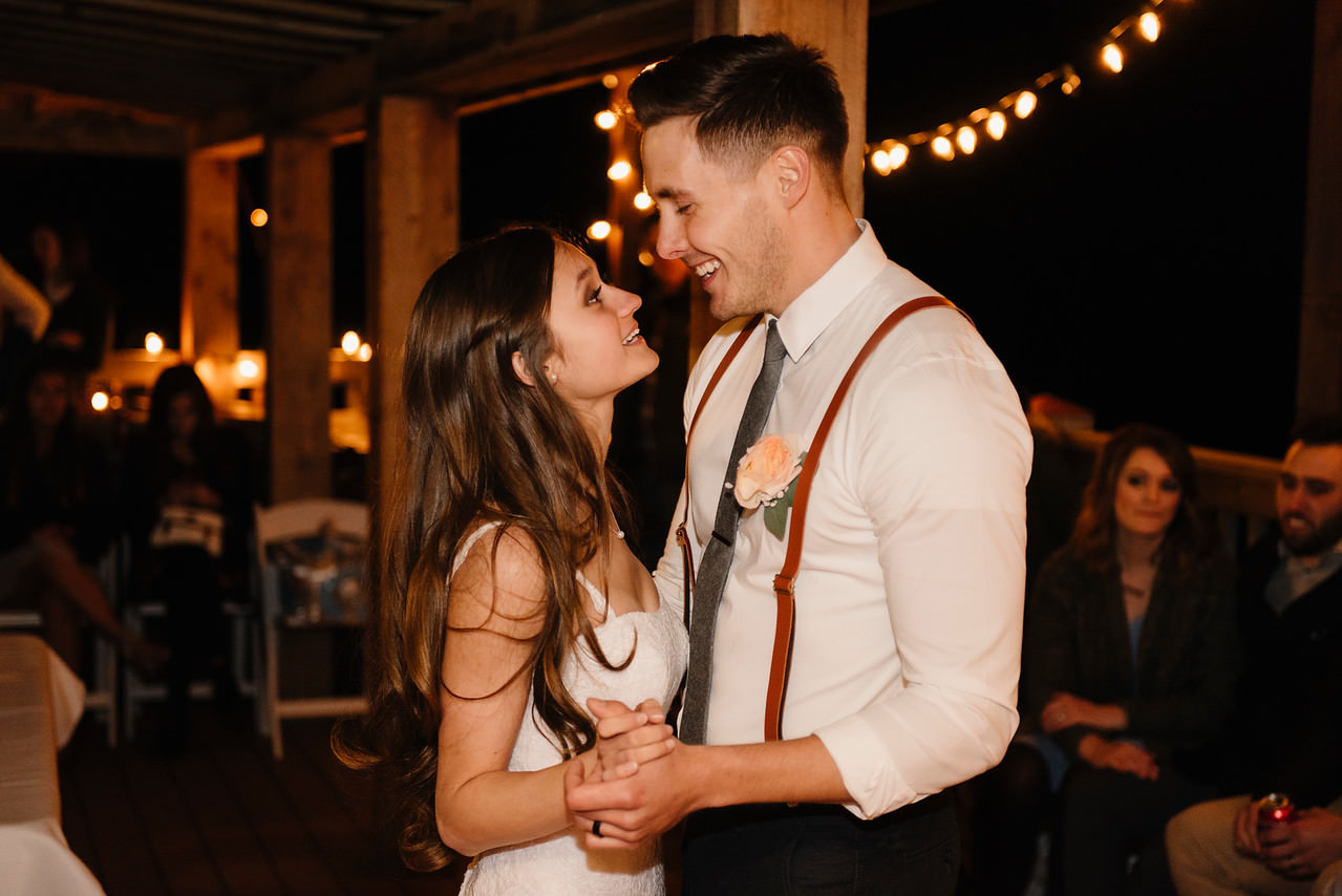 A bride and groom dance under lights after their Buffalo River Wedding by Arkansas Adventure Destination Photographer Colby and Jess