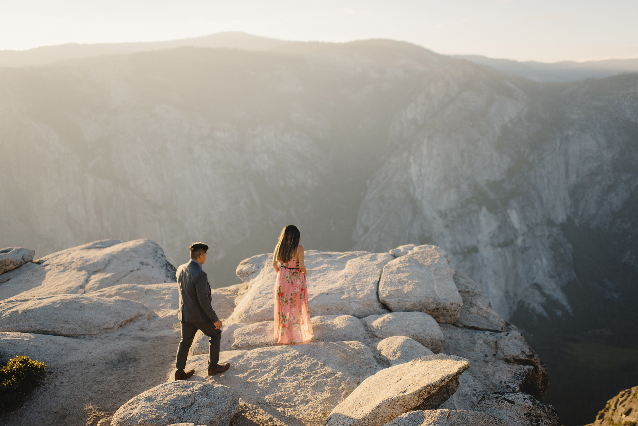Adventurous couple walking to edge of Taft Point for engagement photography by Yosemite wedding photographer Colby and Jess  colbyandjess.com
