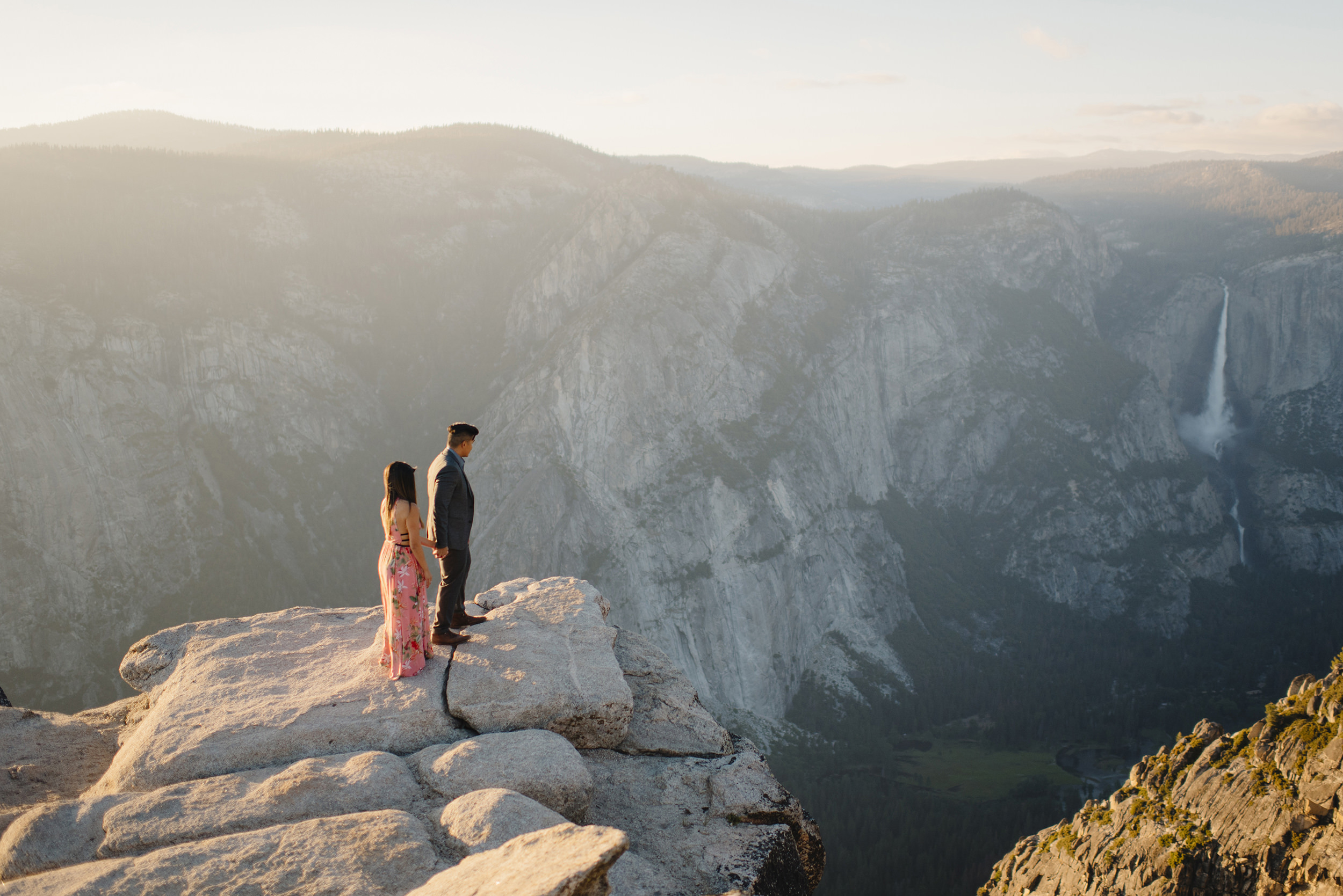 Daring couple look down on Yosemite Valley during engagement photography by Yosemite Wedding Photographer Colby and Jess  colbyandjess.com