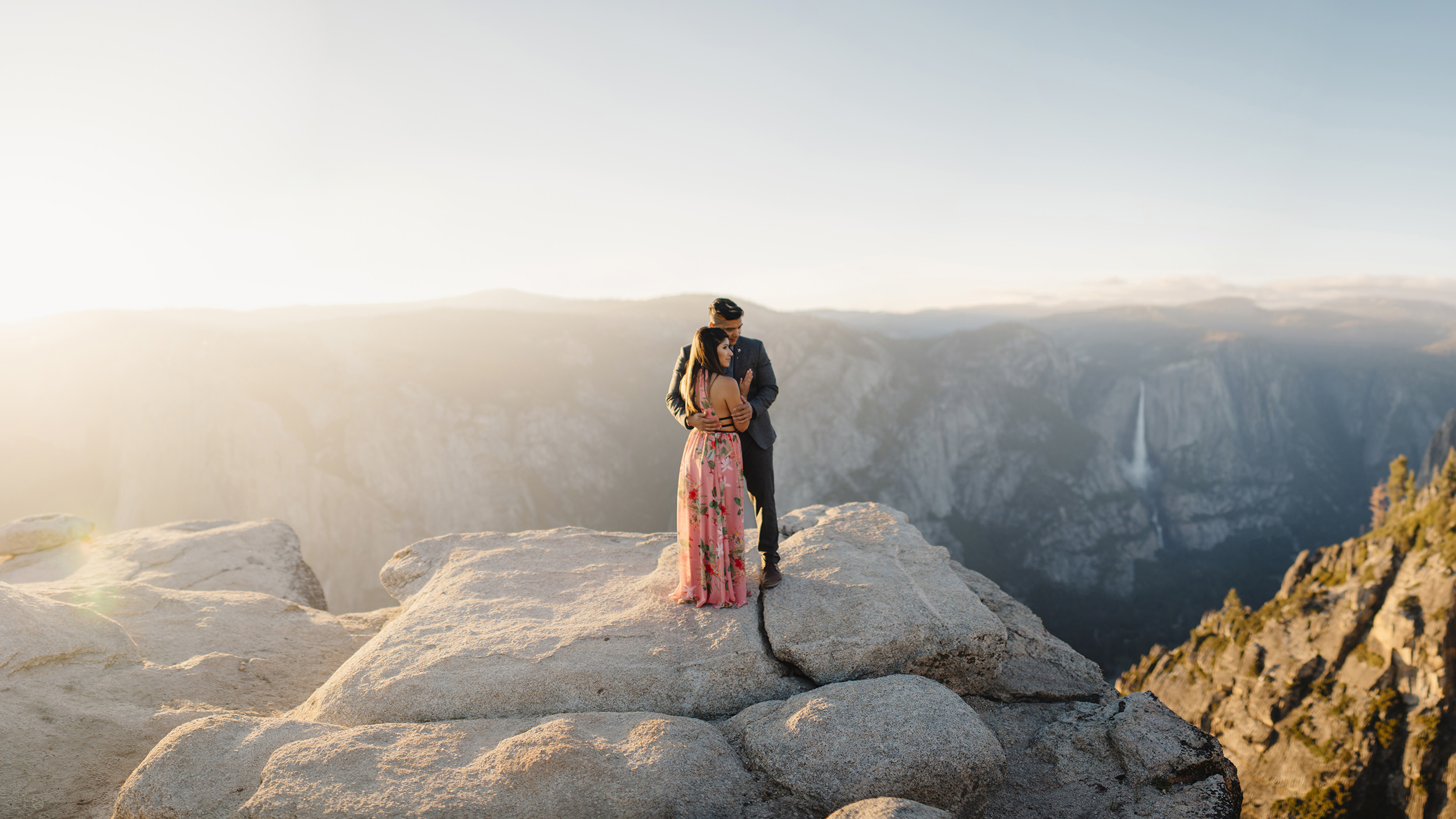 Panoramic view of engaged couple at Taft point during adventure photography session by Yosemite Wedding Photographer Colby and Jess colbyandjess.com
