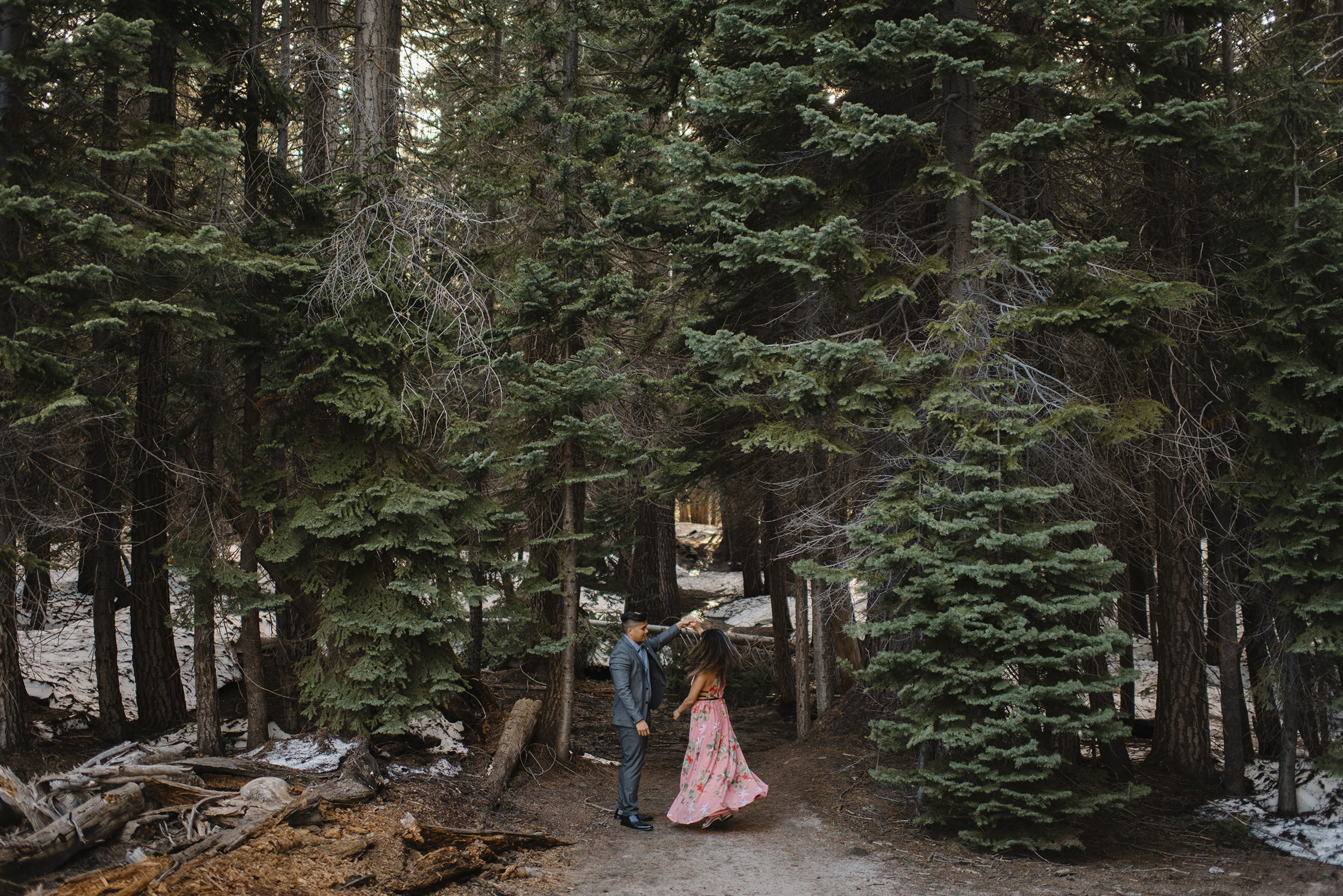 They dance under the redwood trees on the trail to Taft Point.  Romantic Engagement Photography by Yosemite Elopement Photographers Colby and Jess Photography. colbyandjess.com