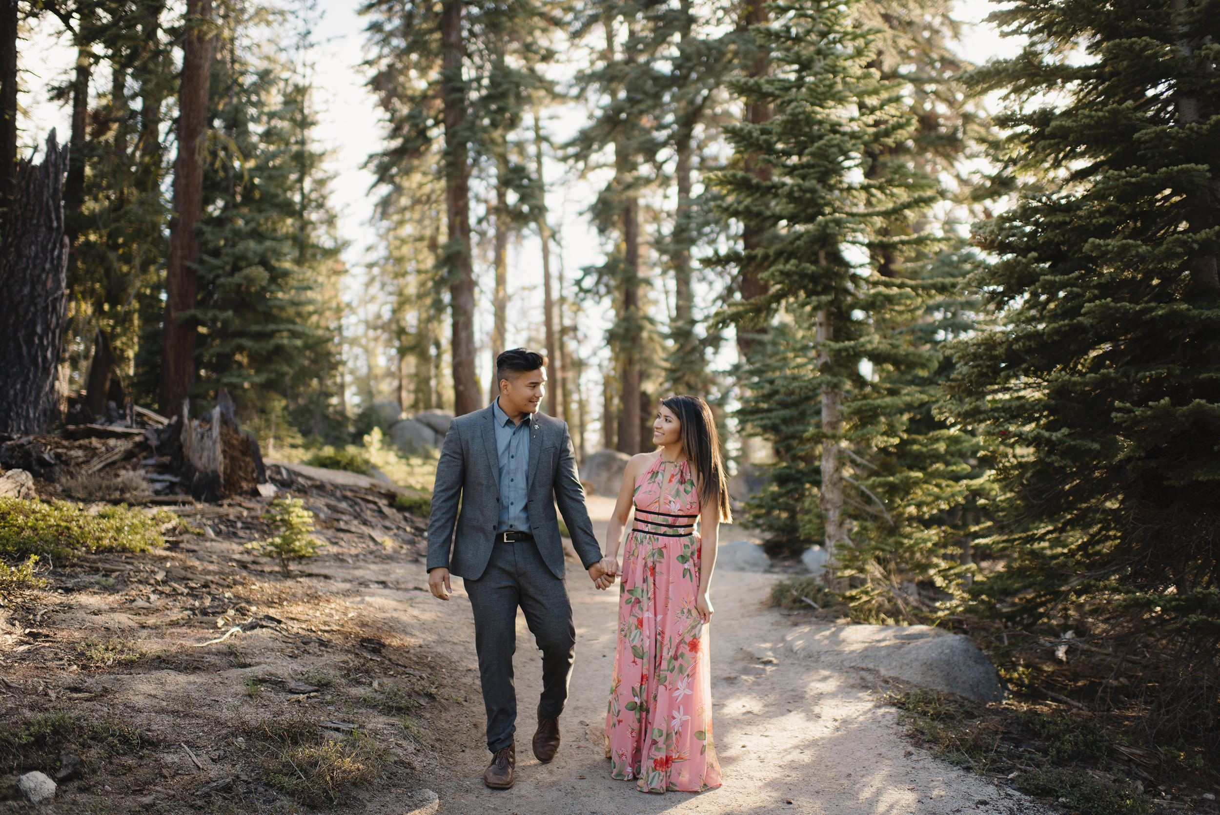 Couple walks holding hands down Taft Point Trail during Engagement Adventure Session by Yosemite Wedding Photographer Colby and Jess.  colbyandjess.com