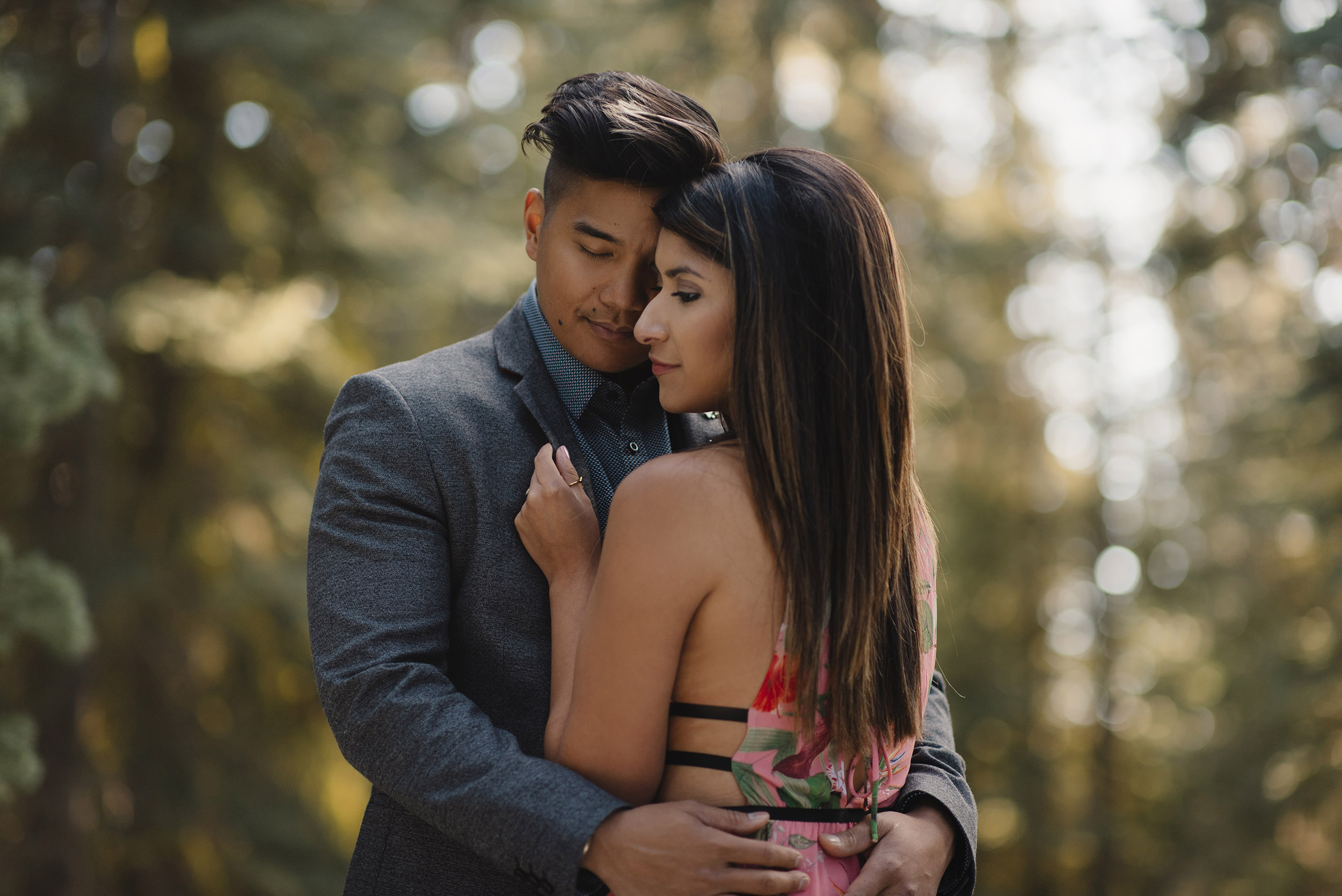 Engaged couple snuggle in close during engagement adventure photography session in Yosmite