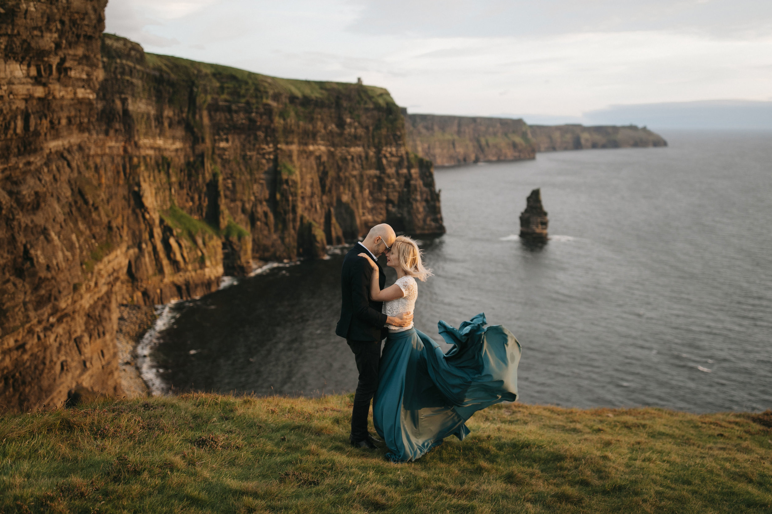 a romantic anniversary session during sunset at the cliffs of moher by adventure photographers colby and jess