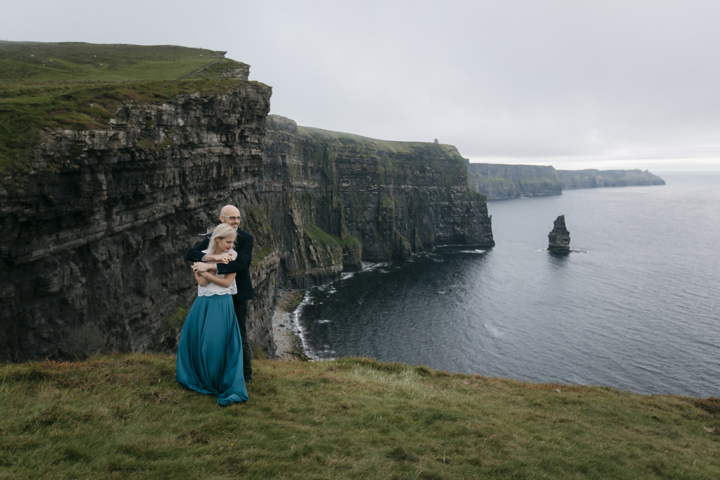 Bohemian couple embrace each other during their epic photography session by Cliffs of Moher Elopement photographers Colby and Jess