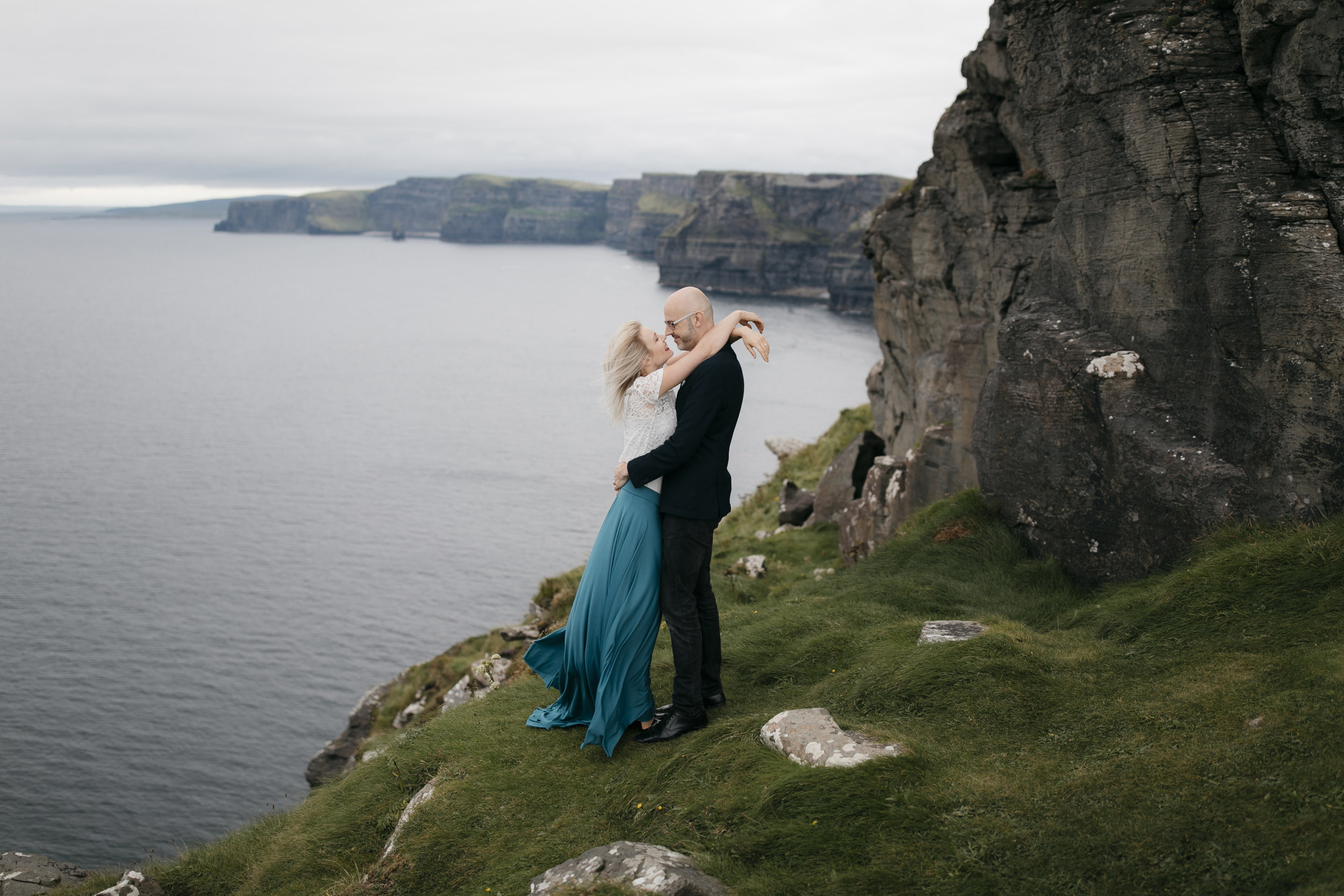 Adventurous couple cherishing each other at the Cliffs of Moher by Ireland Elopement Photographer Colby and Jess