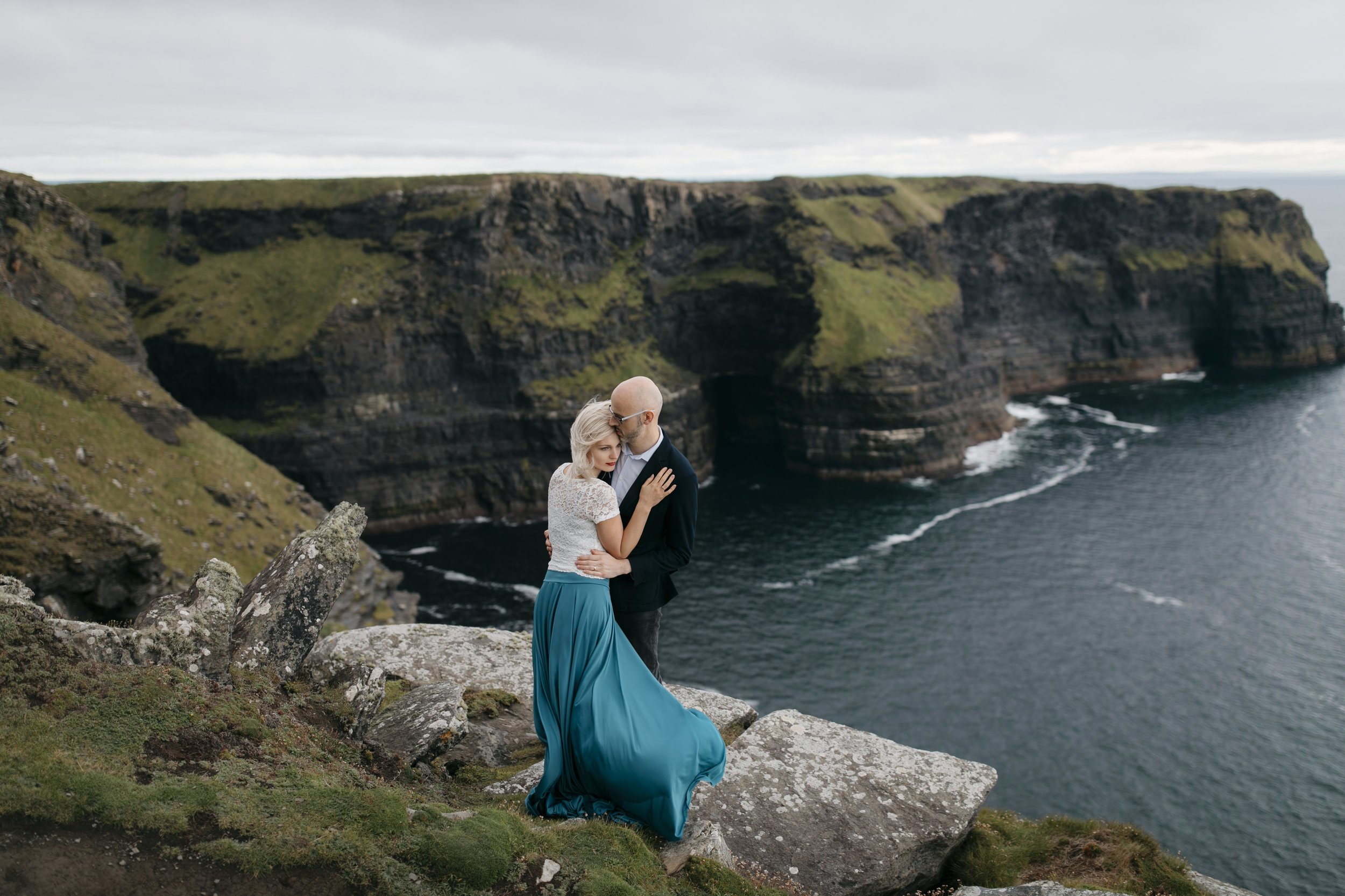Adventurous man and woman explore Ireland during their anniversary photography session by Cliffs of Moher elopement photographers Colby and Jess